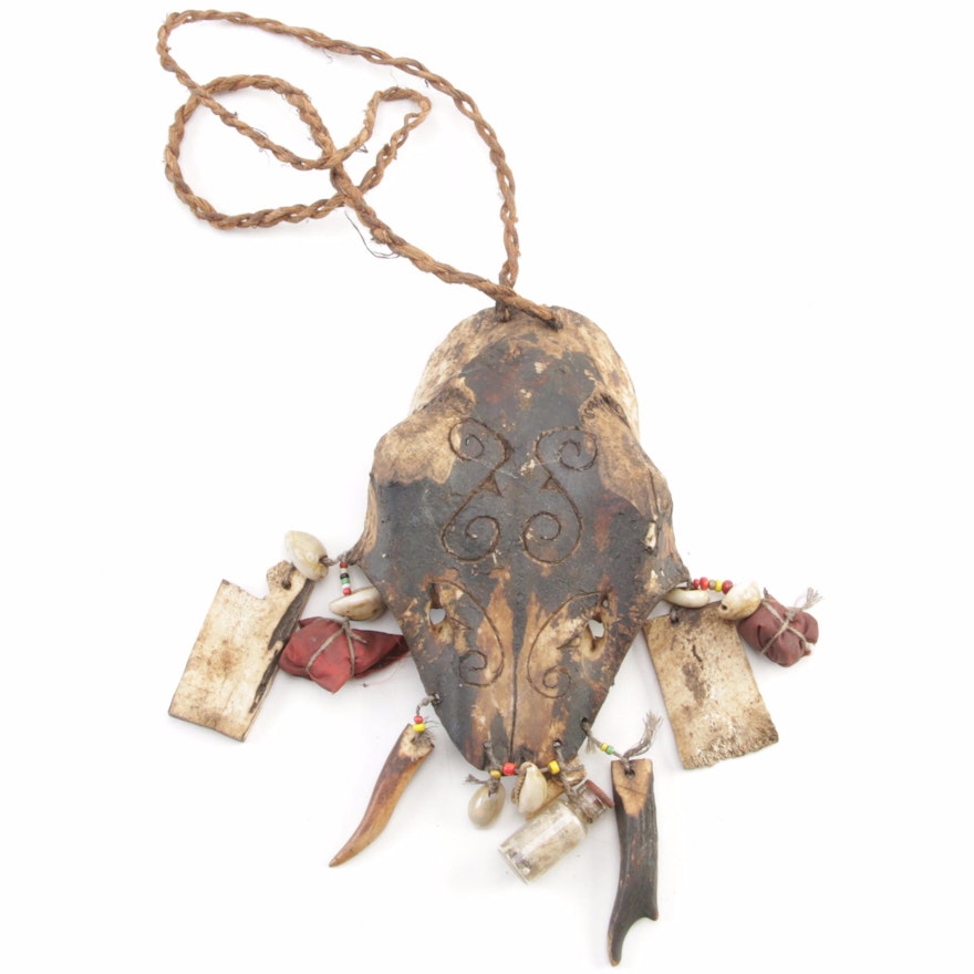 Indonesian Ritual Amulet with Carved Animal Skull, Shell, Bone, and Teeth