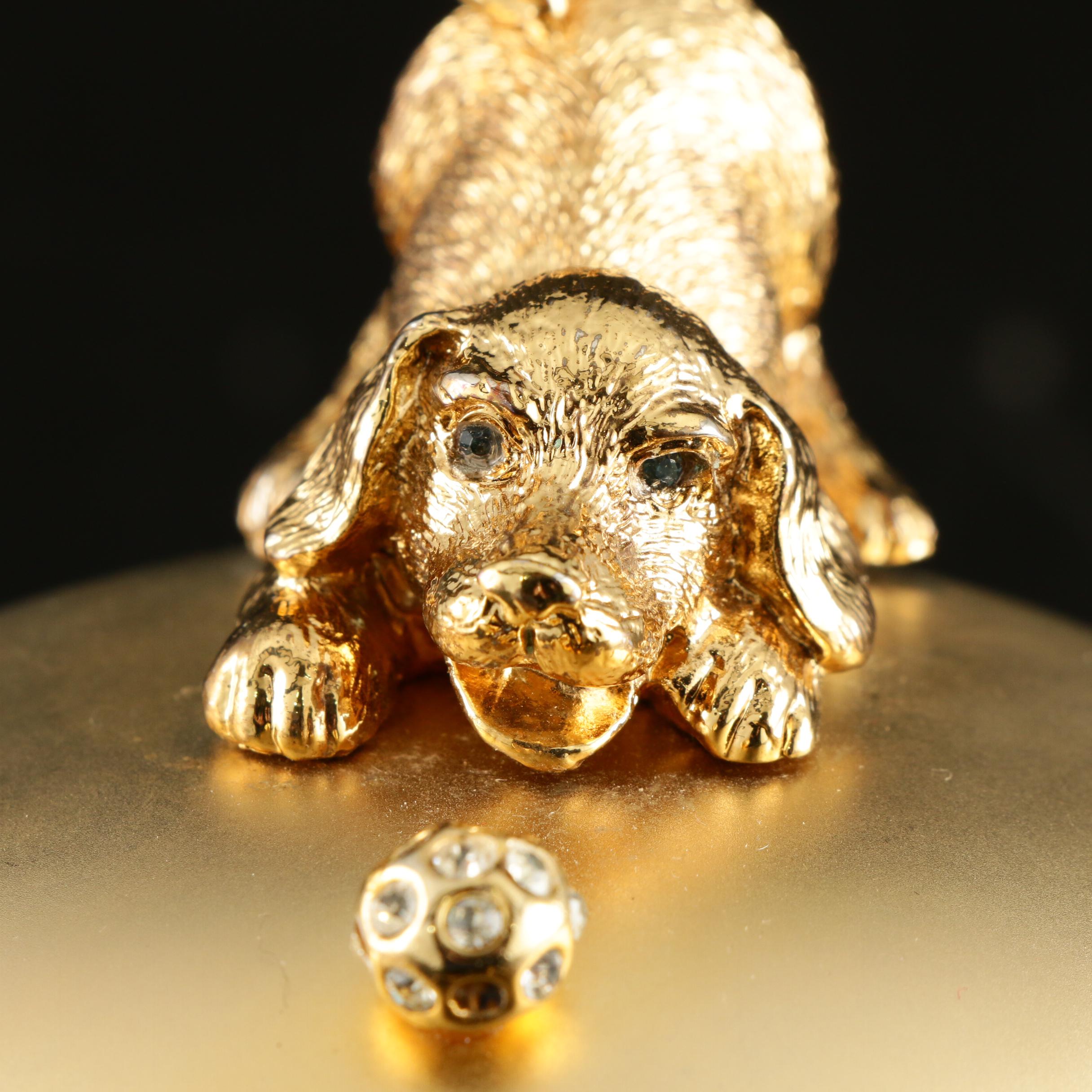 Sasha Evening Bag in Gold Tone Finish Depicting Dog Playing with Bejeweled Ball