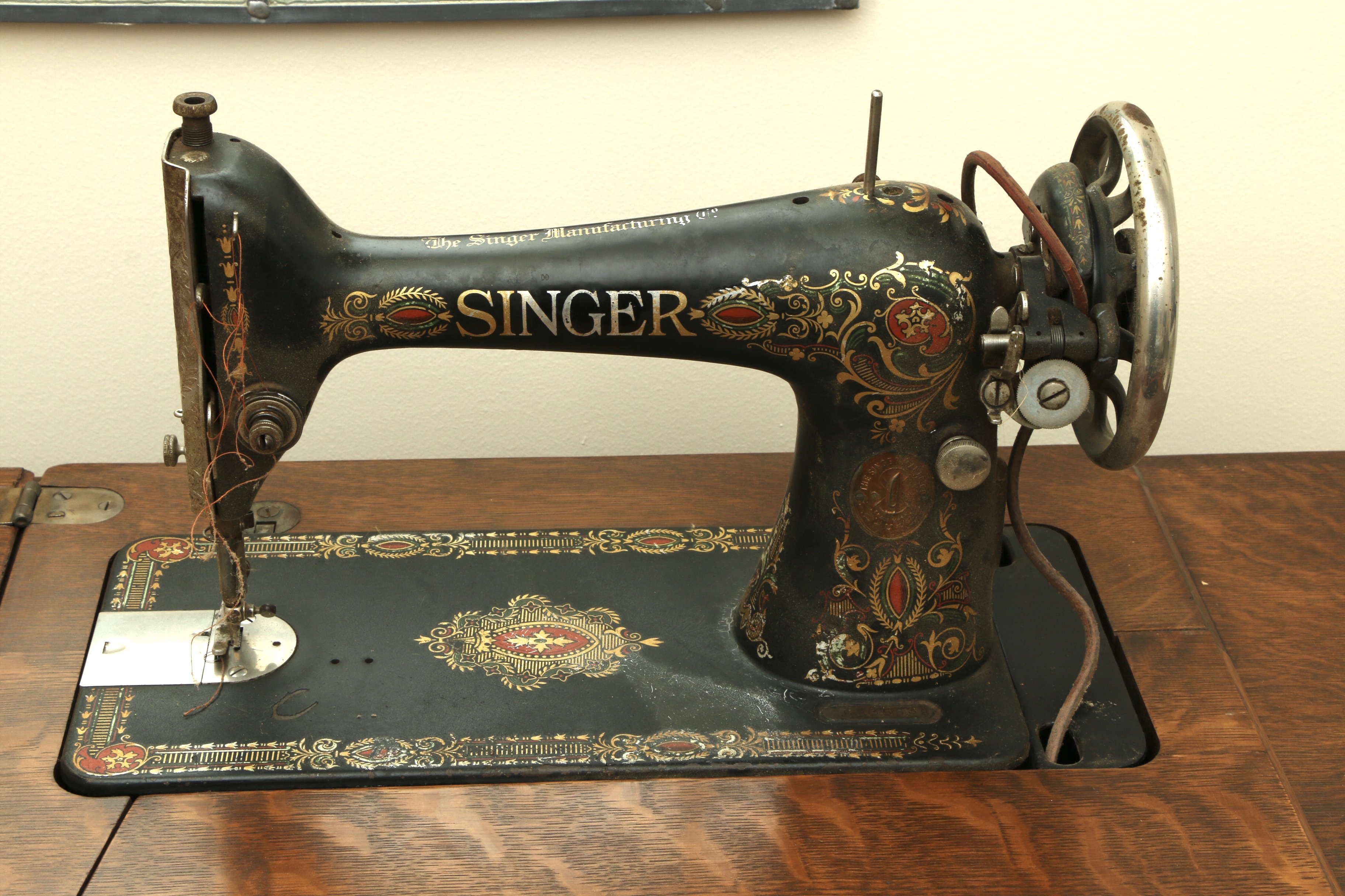 Singer Manufacturing Co. Sewing Machine in Oak Cabinet, Iron Treadle Base, 1919