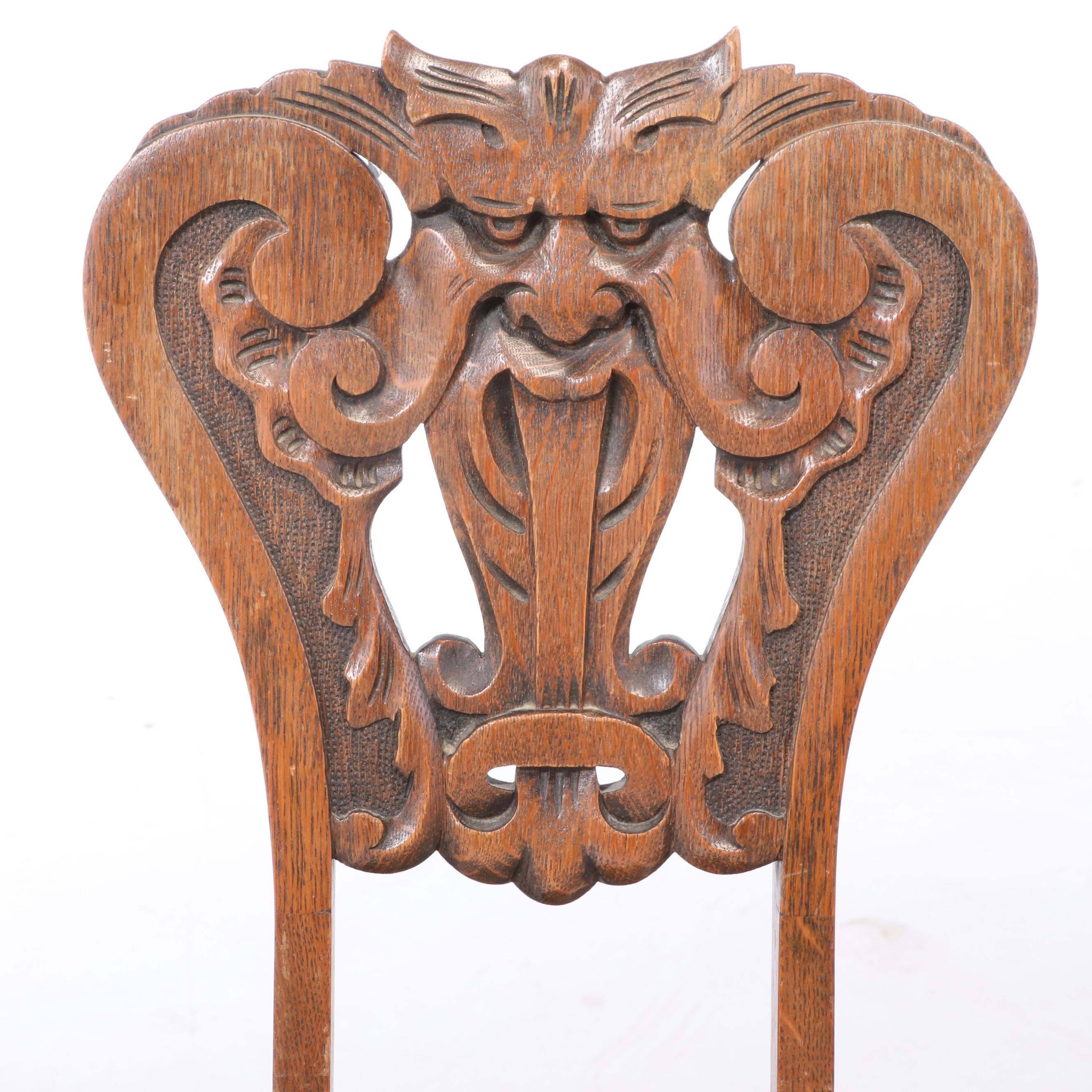 Two American Carved Oak "North Wind" Chairs, circa 1900
