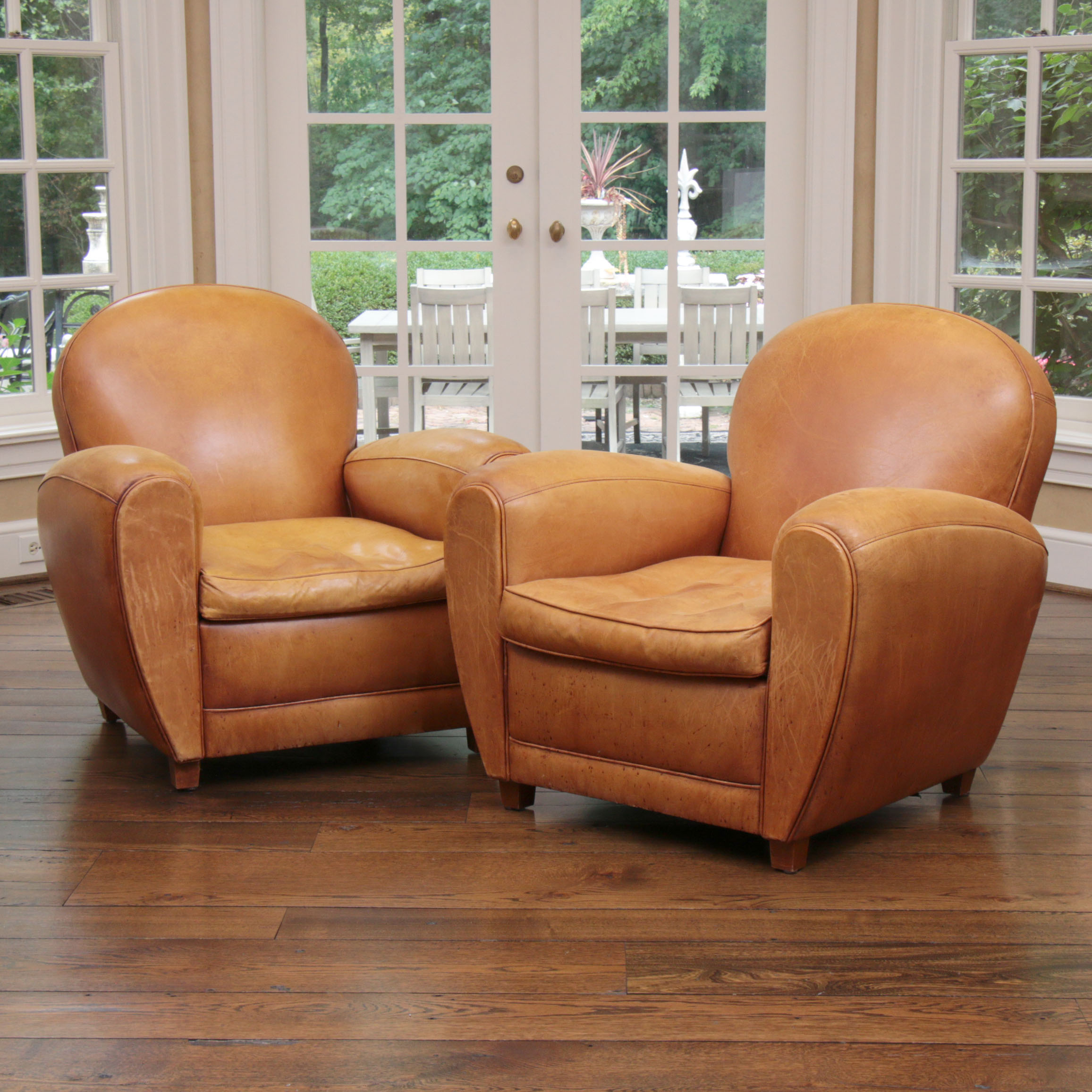 Distressed Leather Armchairs with Nailhead Trim by Centners Design