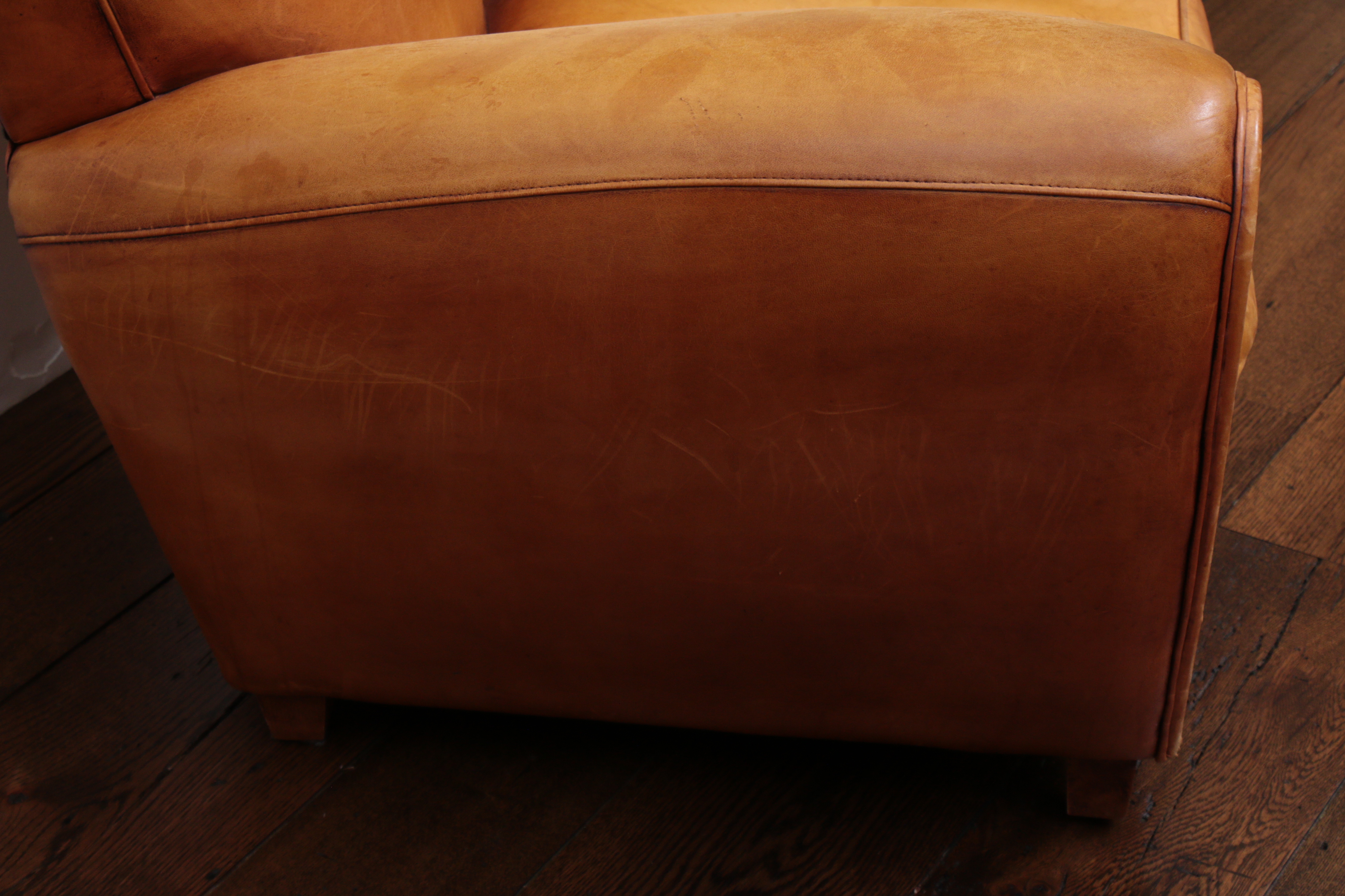 Distressed Leather Armchairs with Nailhead Trim by Centners Design