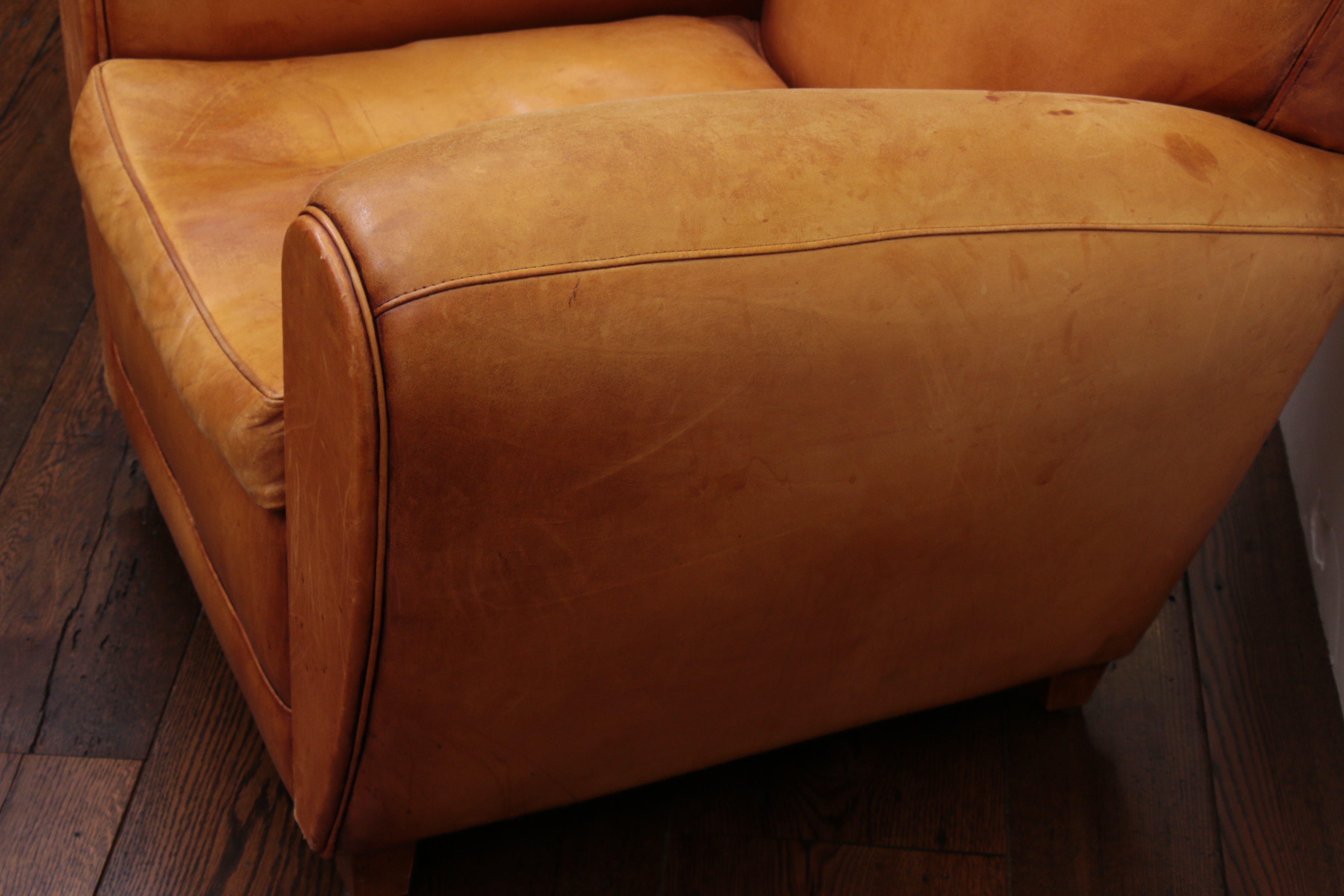 Distressed Leather Armchairs with Nailhead Trim by Centners Design