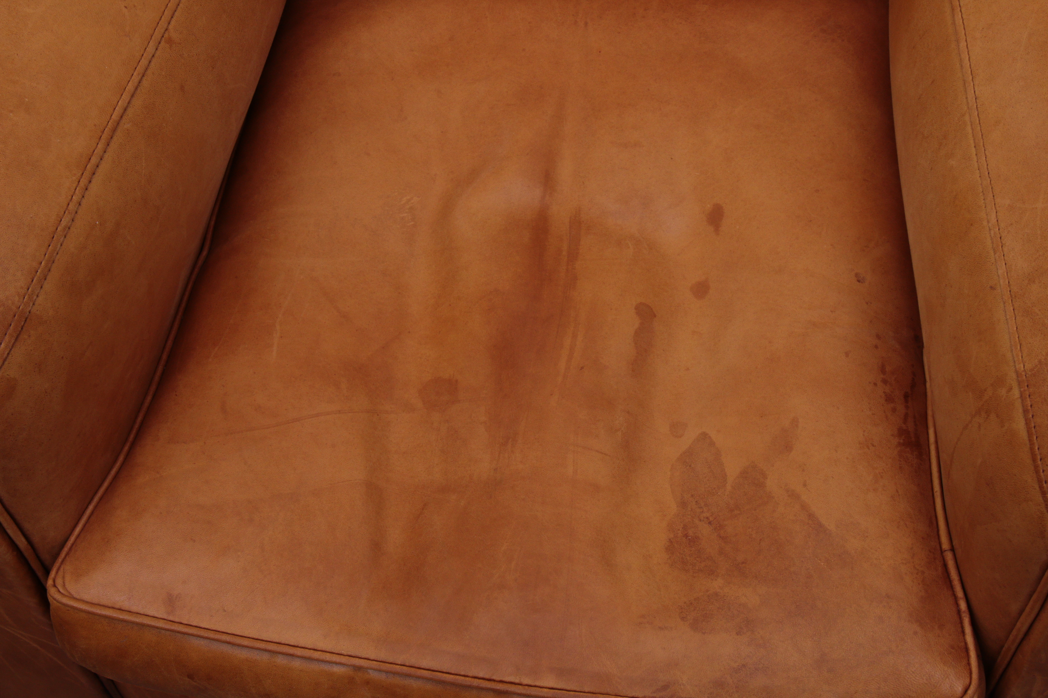 Distressed Leather Armchairs with Nailhead Trim by Centners Design