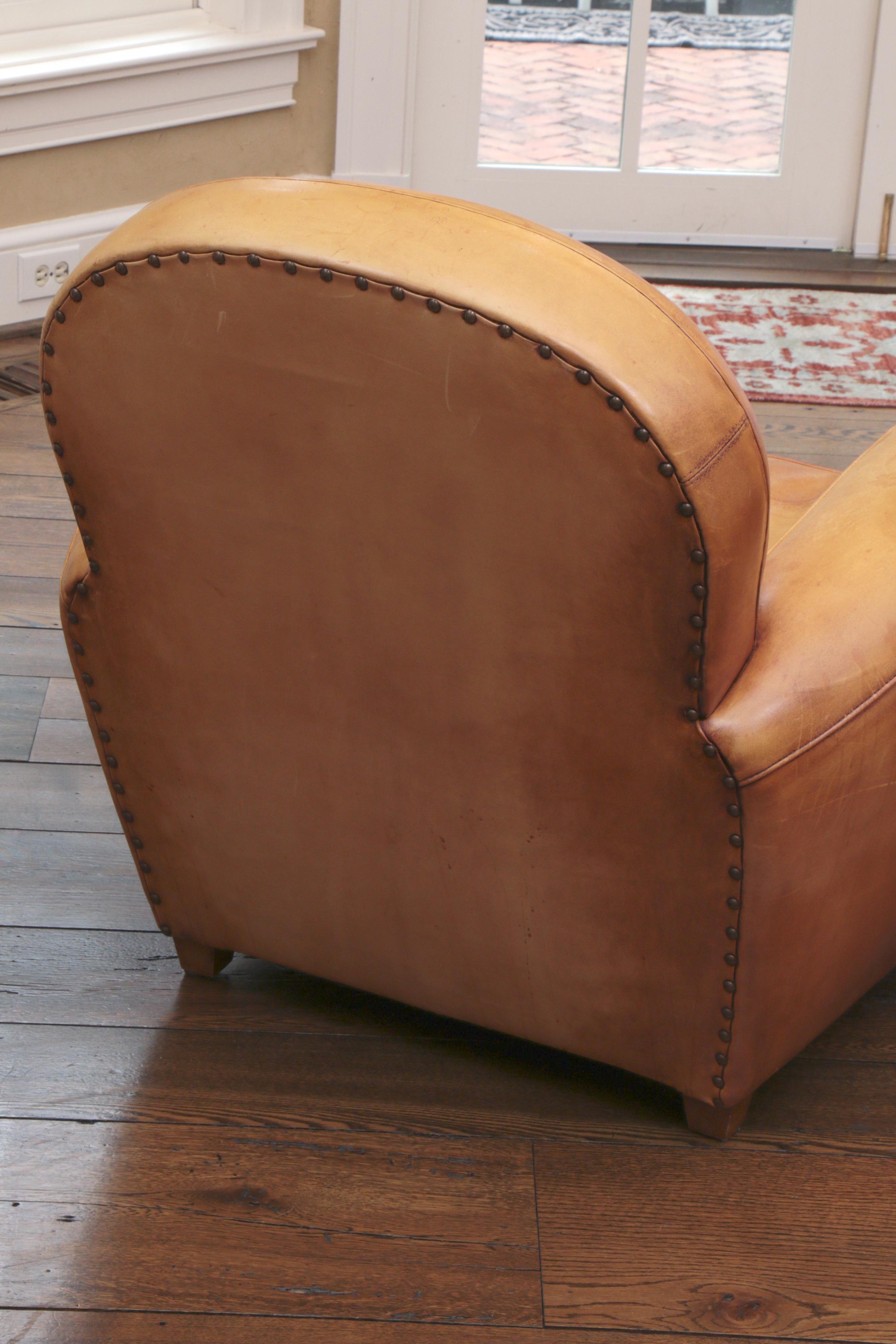 Distressed Leather Armchairs with Nailhead Trim by Centners Design