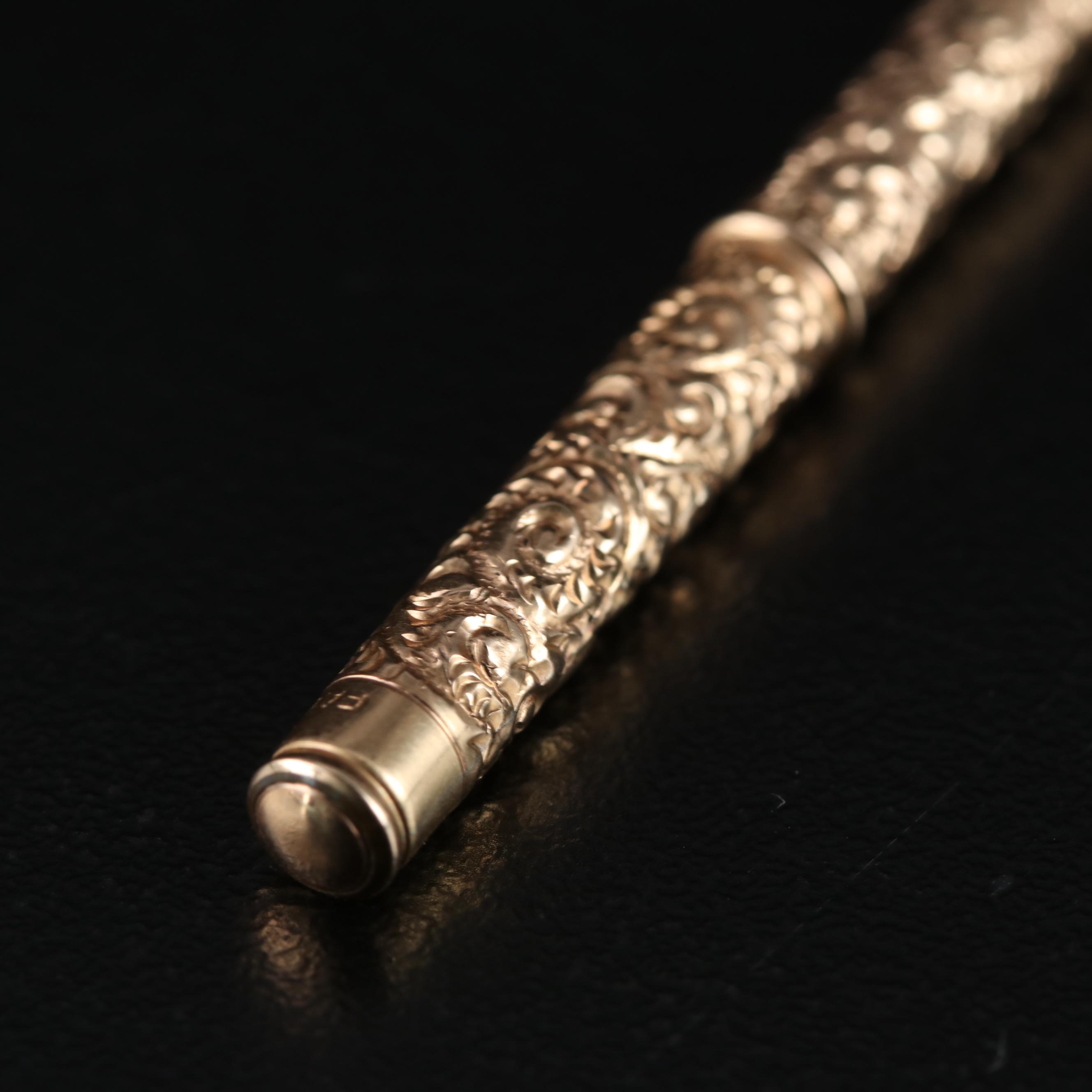 Late Victorian Fairchild Gold Tone Chased Metal Retractable Toothpick