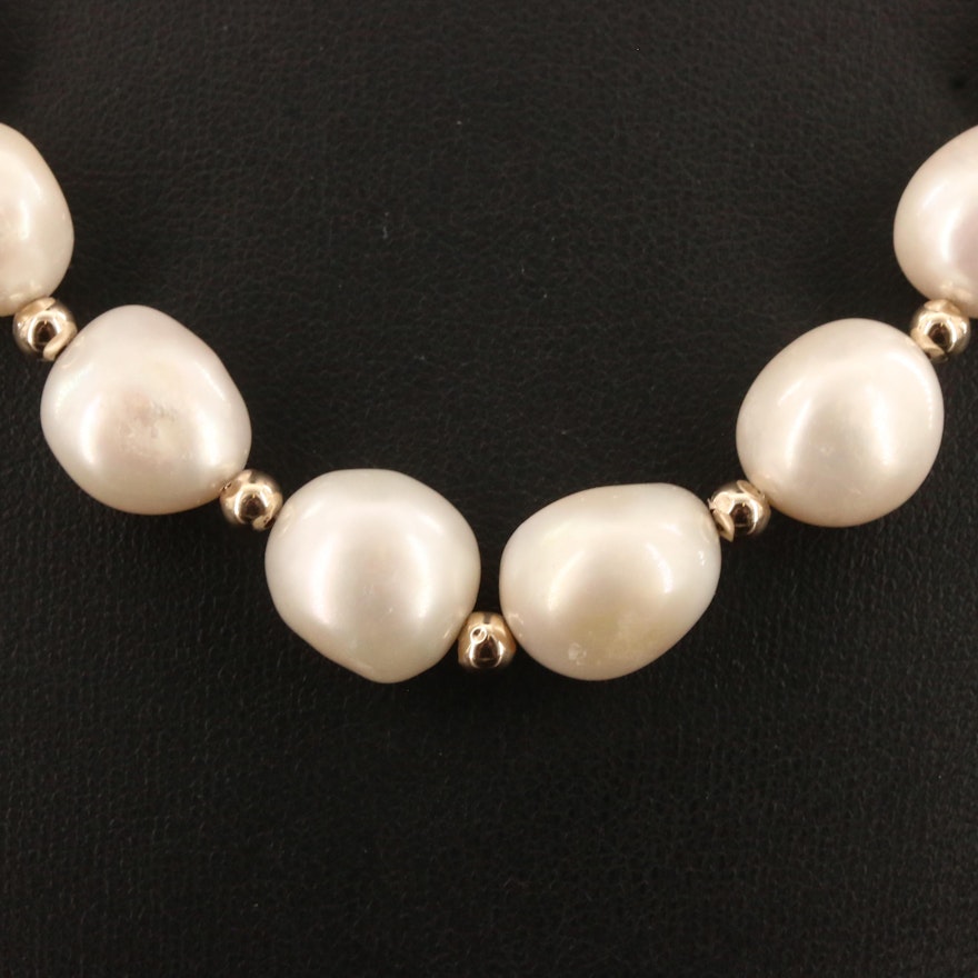 Strand of Oval Semi-Baroque Pearls with 14K Findings