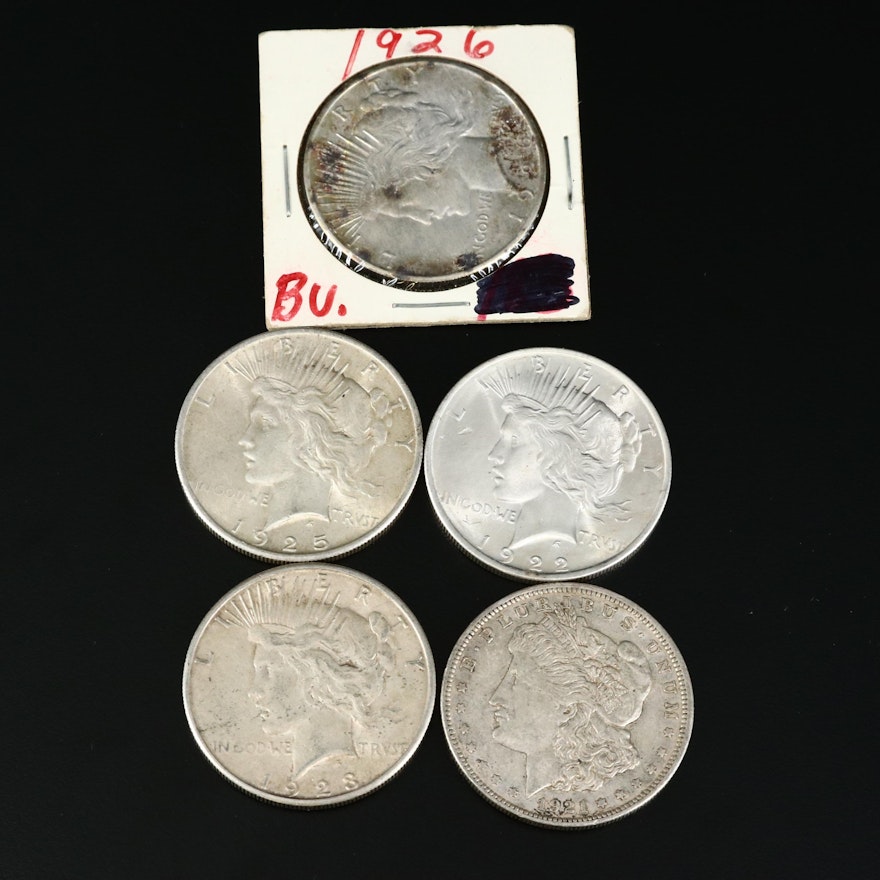 One Morgan and Four Peace Silver Dollars