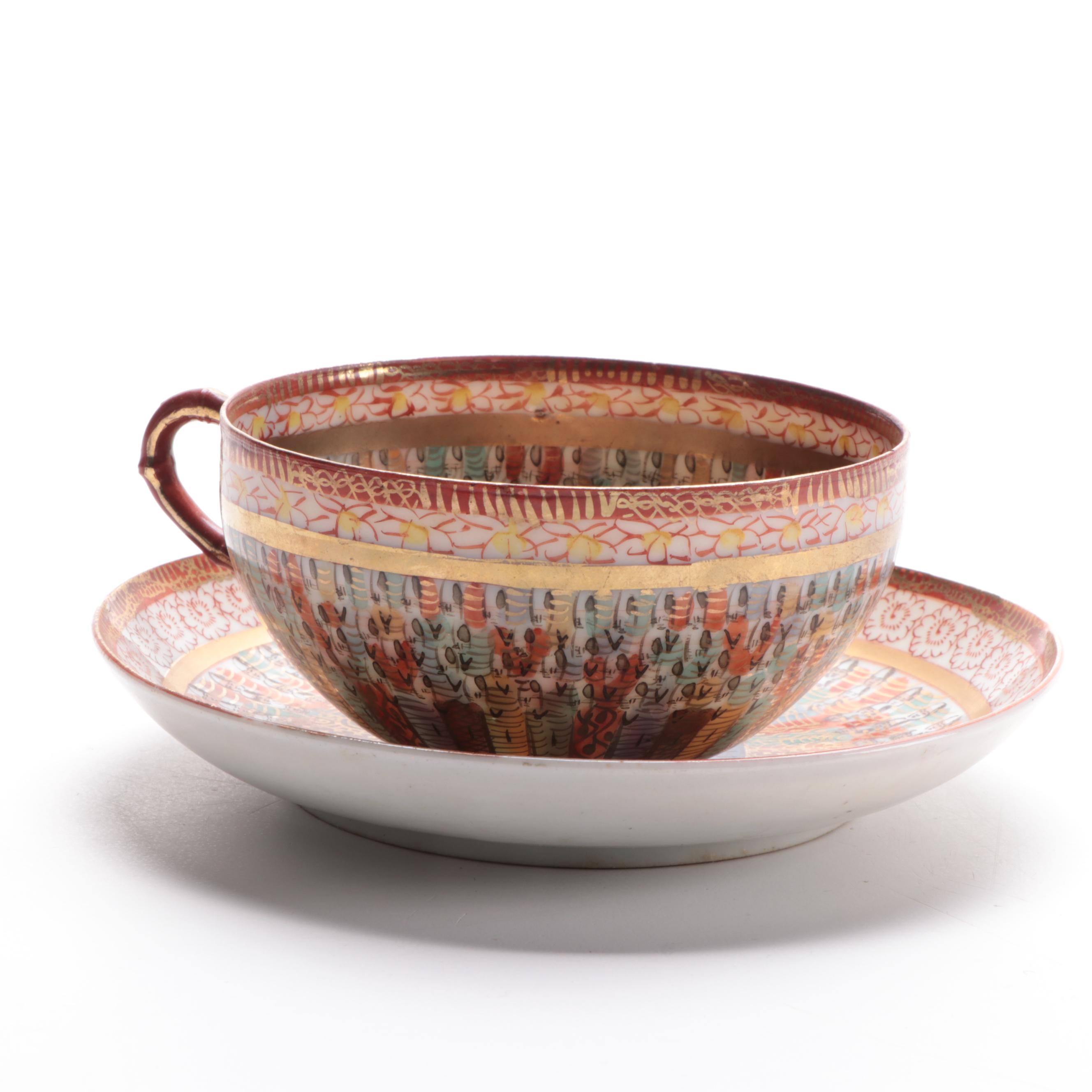 Japanese Kutani Ware "Thousand Faces" Porcelain Teacup and Saucer