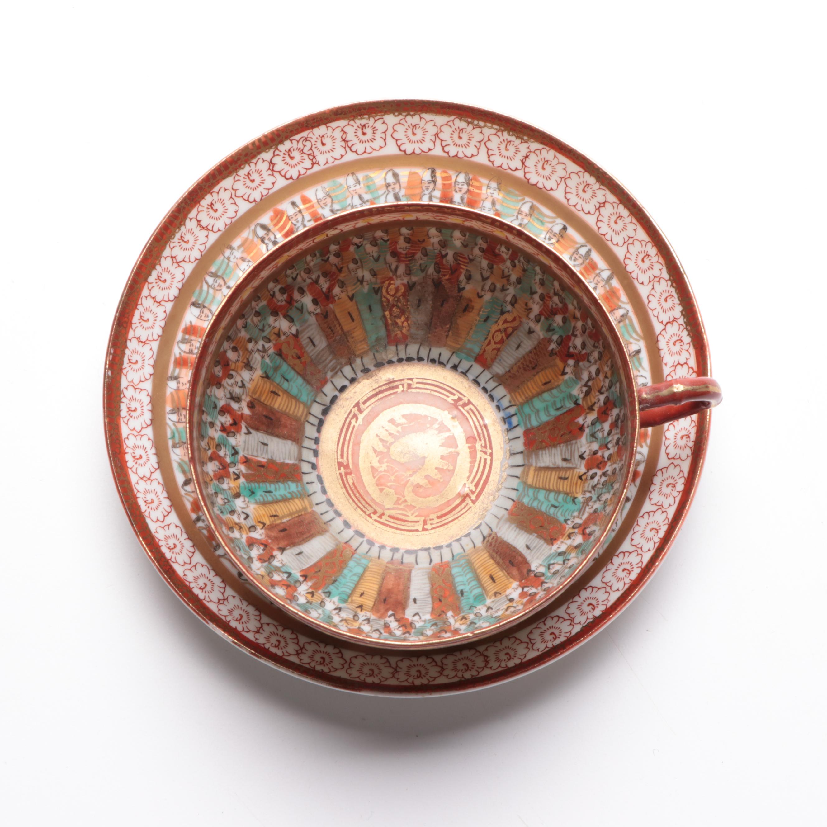 Japanese Kutani Ware "Thousand Faces" Porcelain Teacup and Saucer
