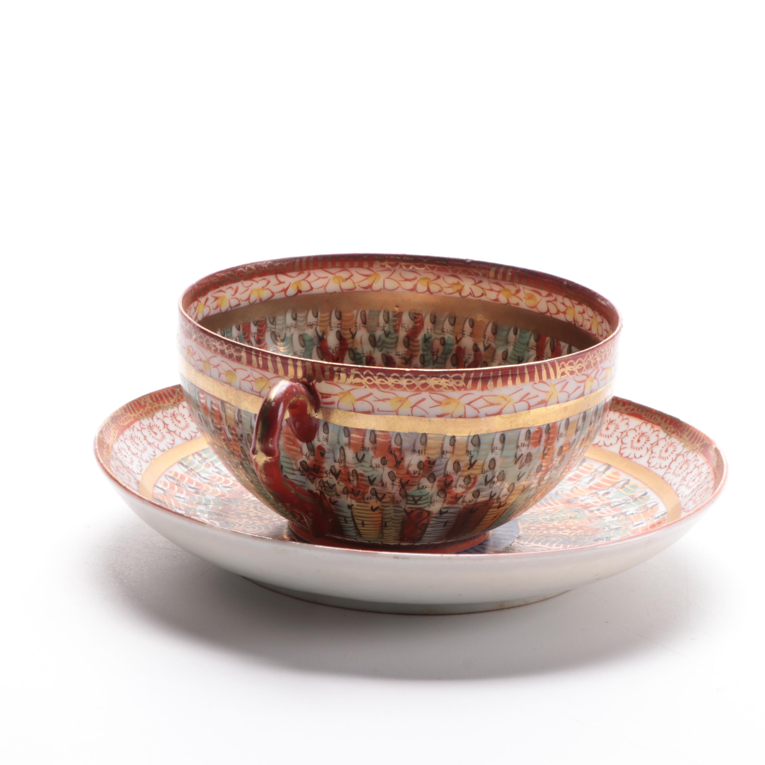 Japanese Kutani Ware "Thousand Faces" Porcelain Teacup and Saucer