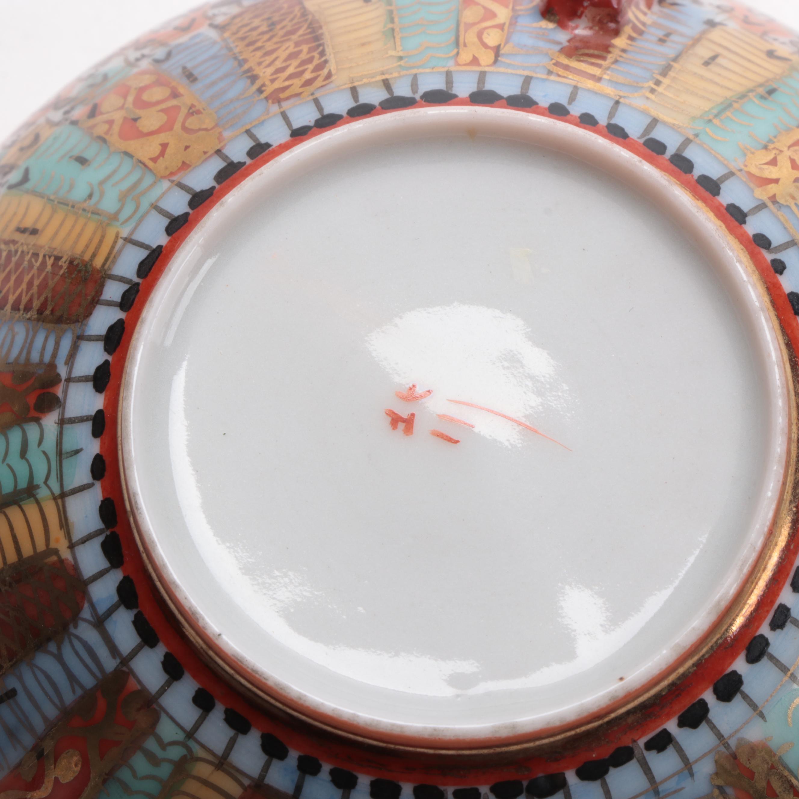 Japanese Kutani Ware "Thousand Faces" Porcelain Teacup and Saucer