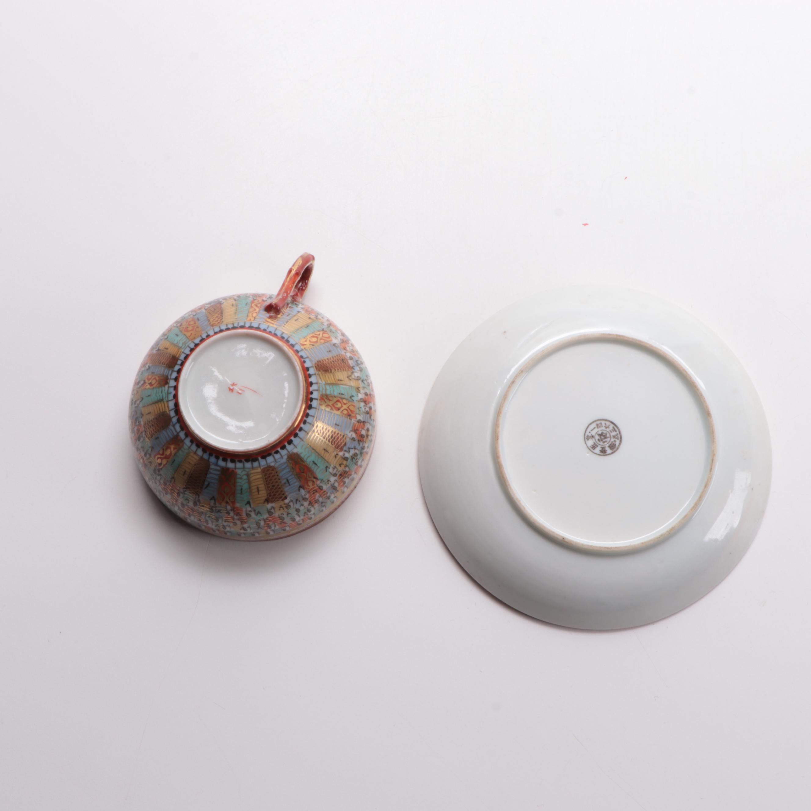 Japanese Kutani Ware "Thousand Faces" Porcelain Teacup and Saucer