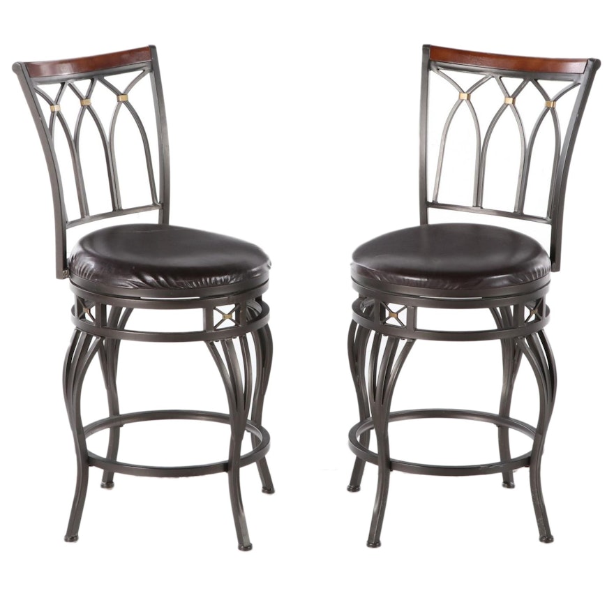 Pair of Cheyenne Ind. Hardwood-Mounted and Patinated Metal Swivel Bar Stools