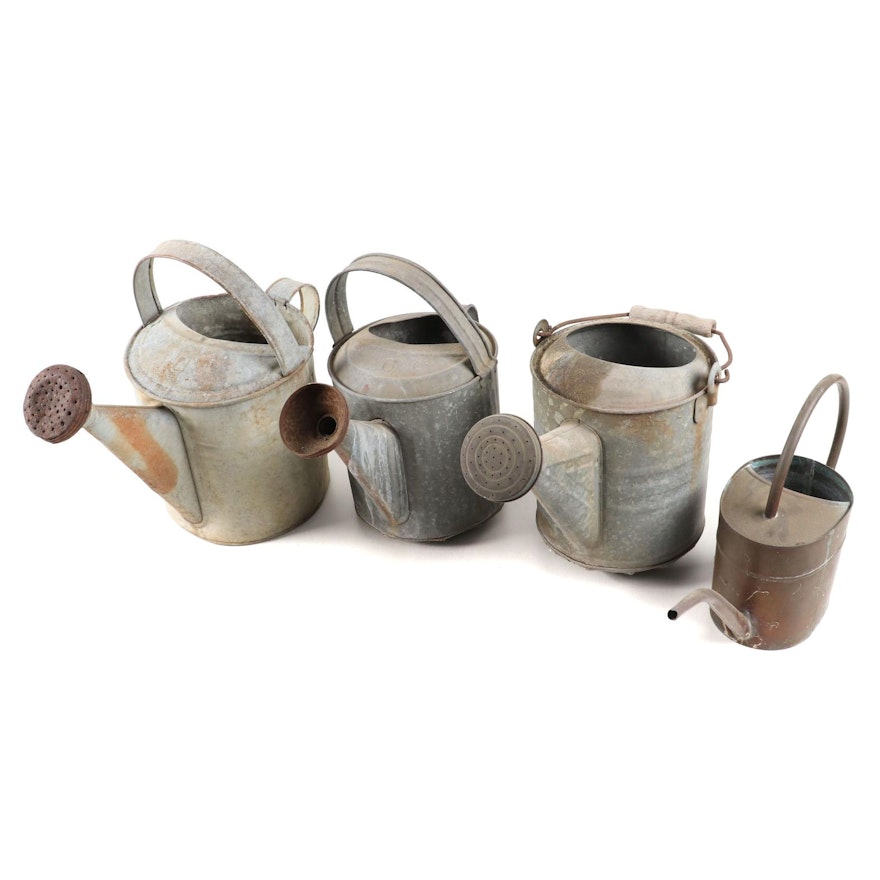 Three Galvanized Metal Watering Cans and One Copper Indoor Watering Can