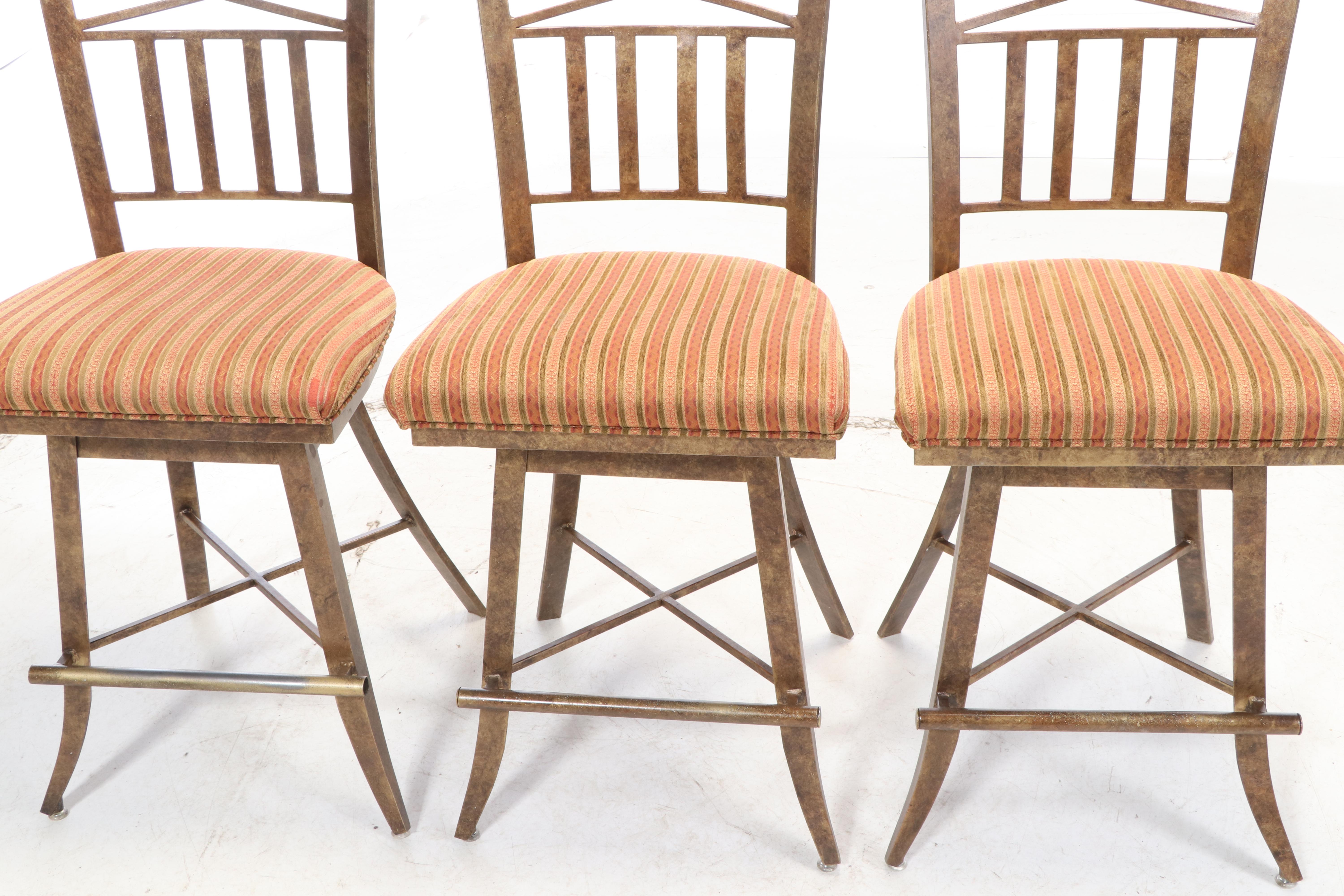 Three Kessler Industries Patinated Metal Counter-Height Swivel Bar Stools