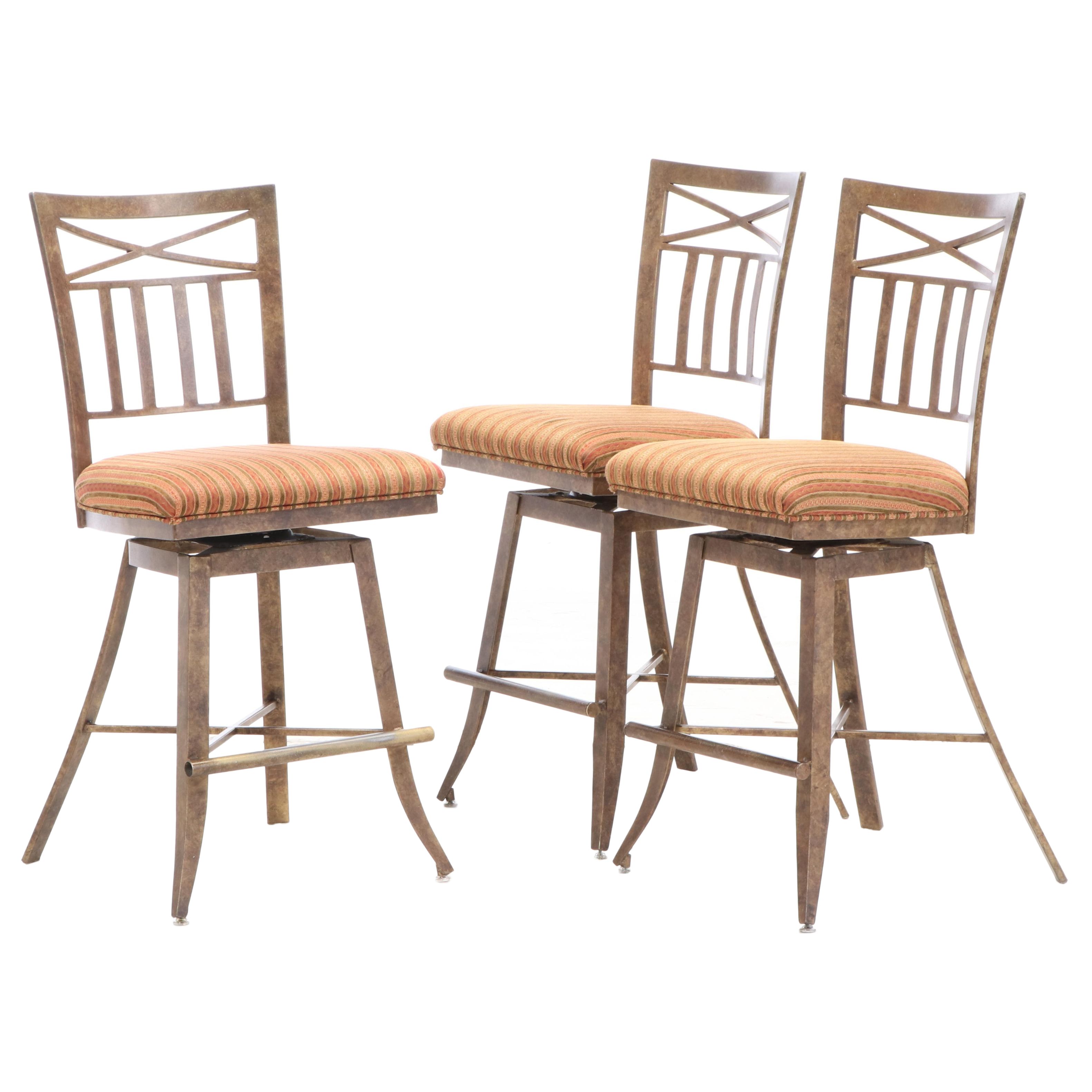 Three Kessler Industries Patinated Metal Counter-Height Swivel Bar Stools
