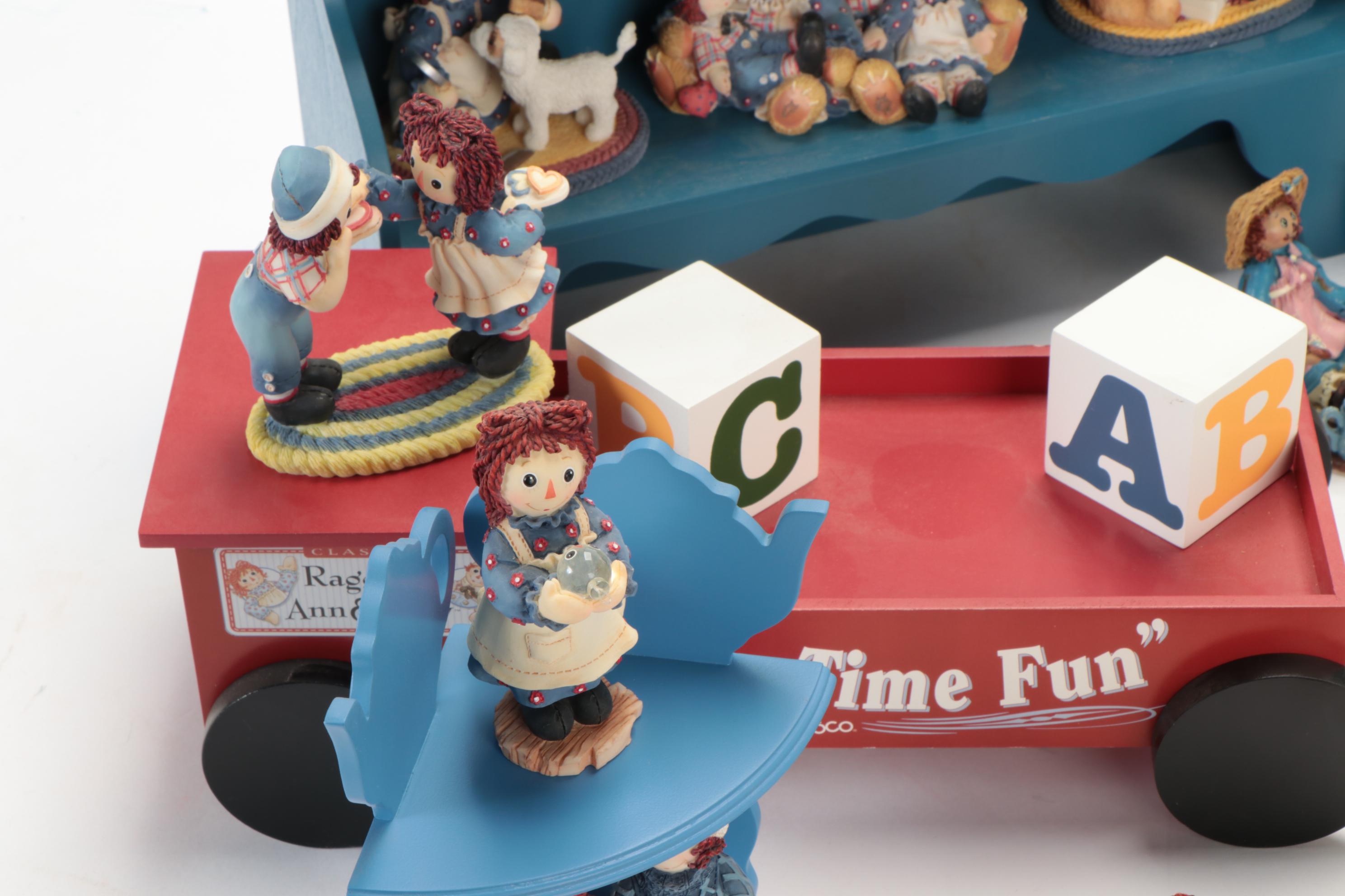 Enesco and Other Raggedy Ann & Andy Figurines with Display Shelves