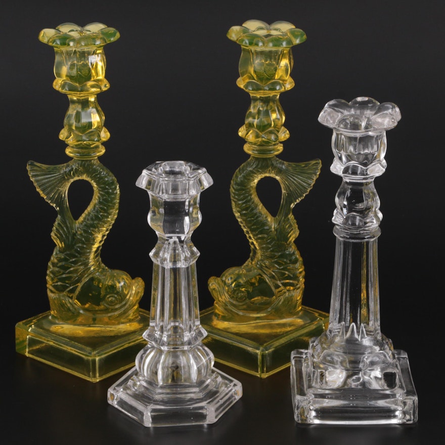 Pair of Vaseline Glass Dolphin Candlesticks with Other Clear Glass Candlesticks