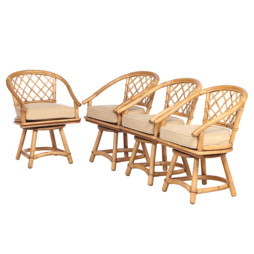 Four Rattan Swivel Arm Chairs