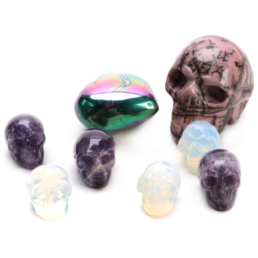 Carved Rhodonite, Amethyst, and Opalite Glass Skulls with Rainbow Hematite Heart