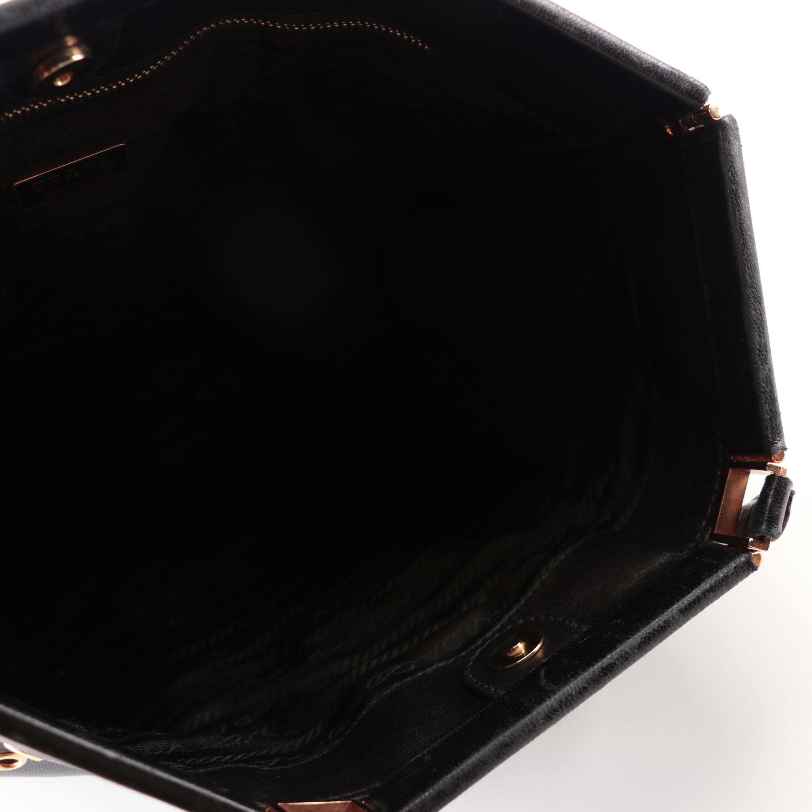 Prada Hinged Flat Shoulder Bag in Black Lambskin with Grommet Detail