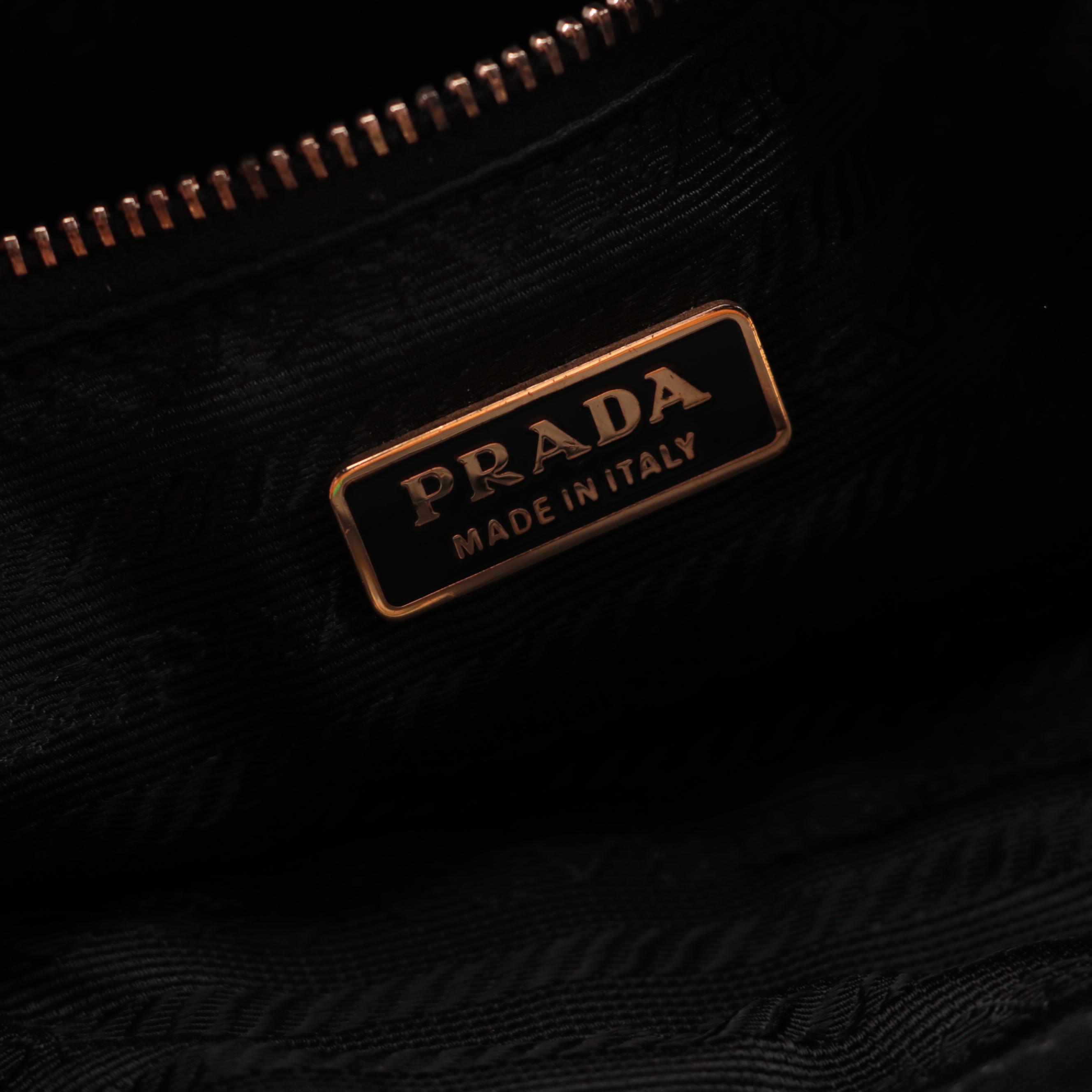 Prada Hinged Flat Shoulder Bag in Black Lambskin with Grommet Detail