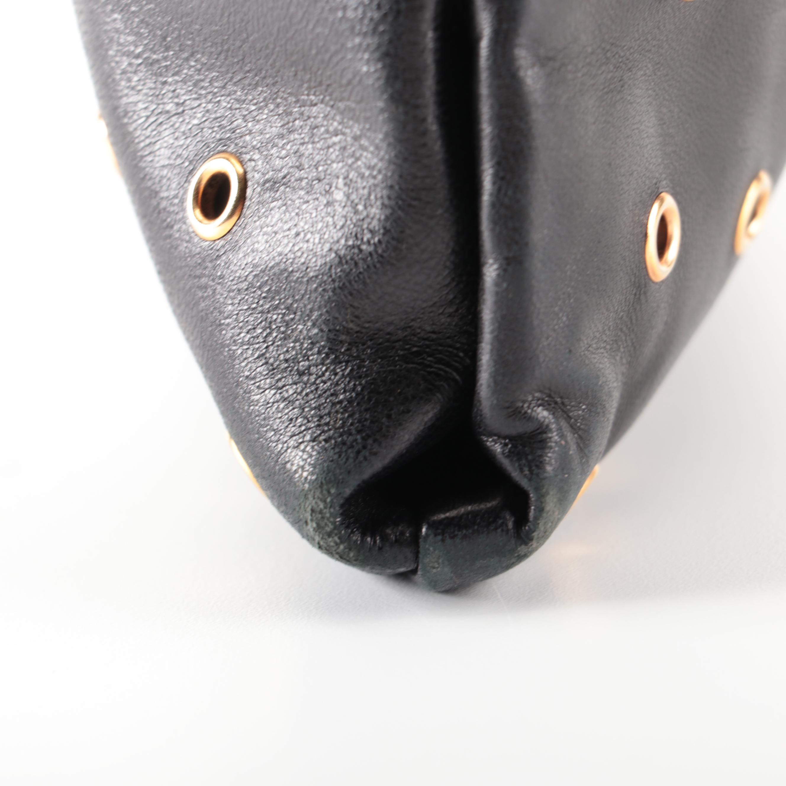 Prada Hinged Flat Shoulder Bag in Black Lambskin with Grommet Detail