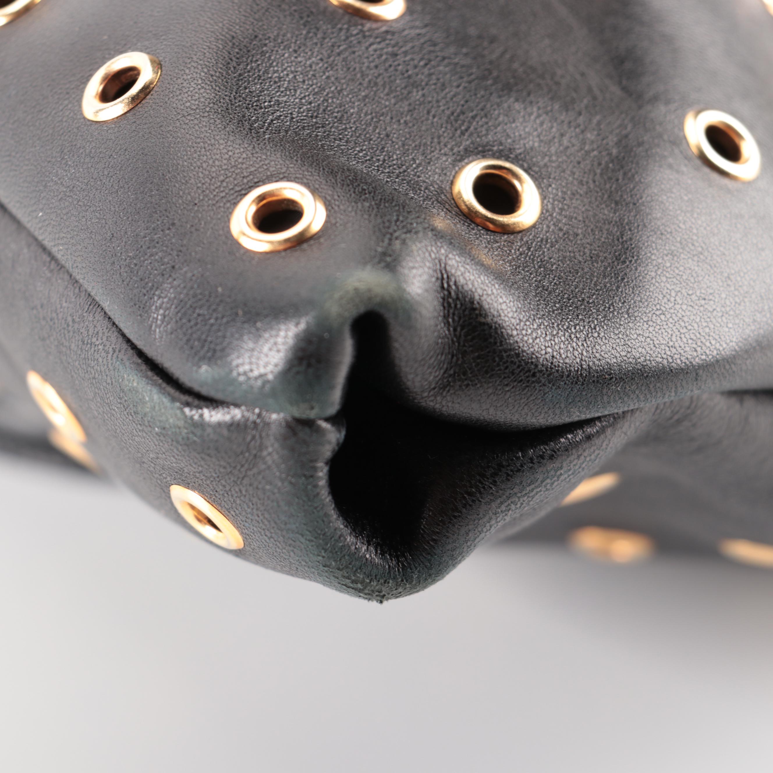 Prada Hinged Flat Shoulder Bag in Black Lambskin with Grommet Detail