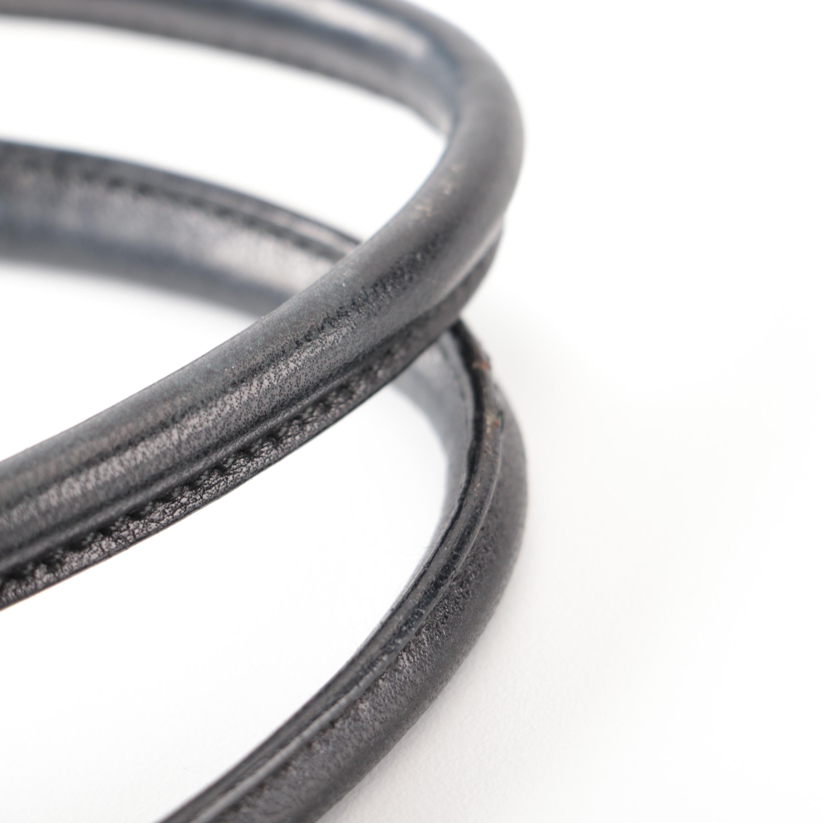 Prada Hinged Flat Shoulder Bag in Black Lambskin with Grommet Detail