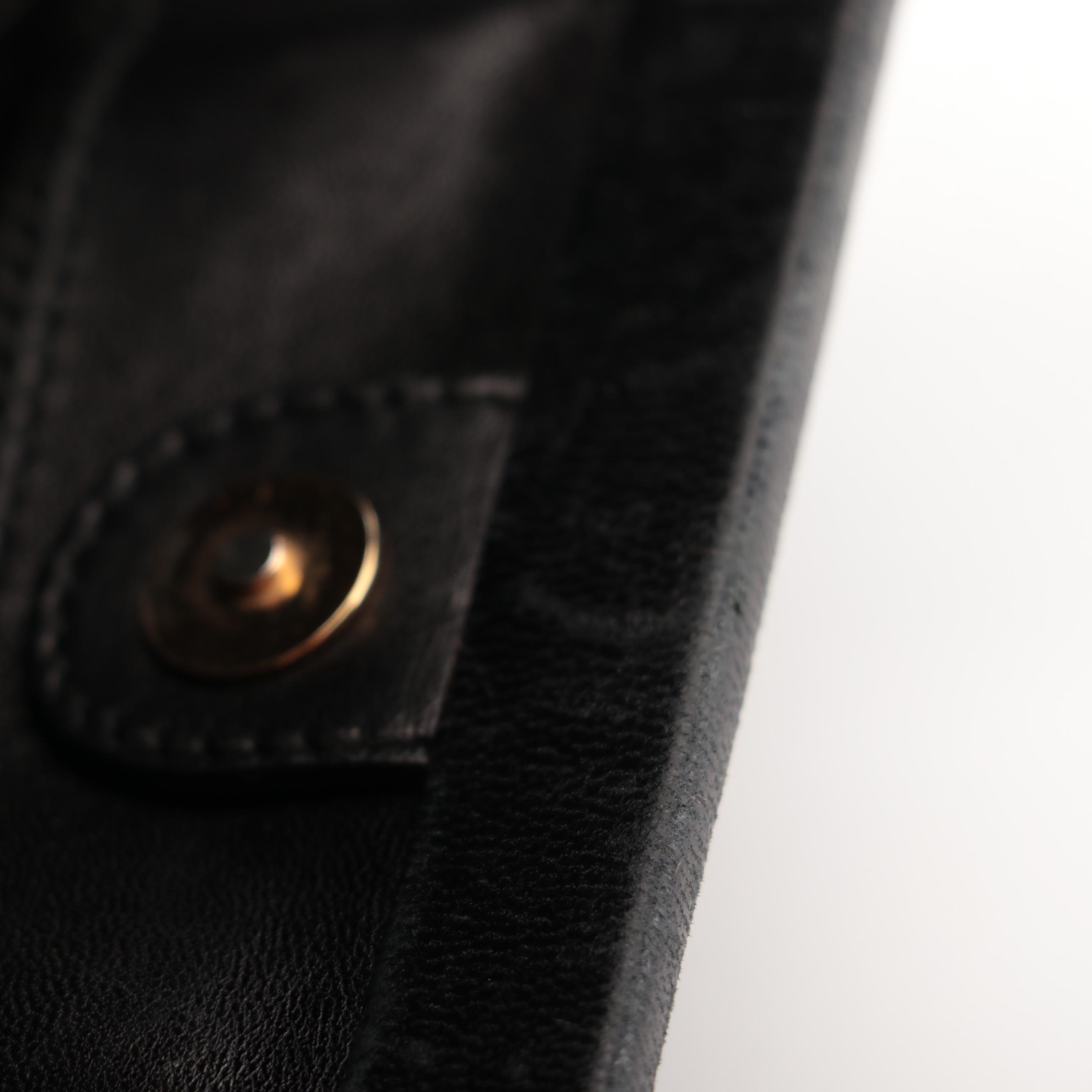 Prada Hinged Flat Shoulder Bag in Black Lambskin with Grommet Detail