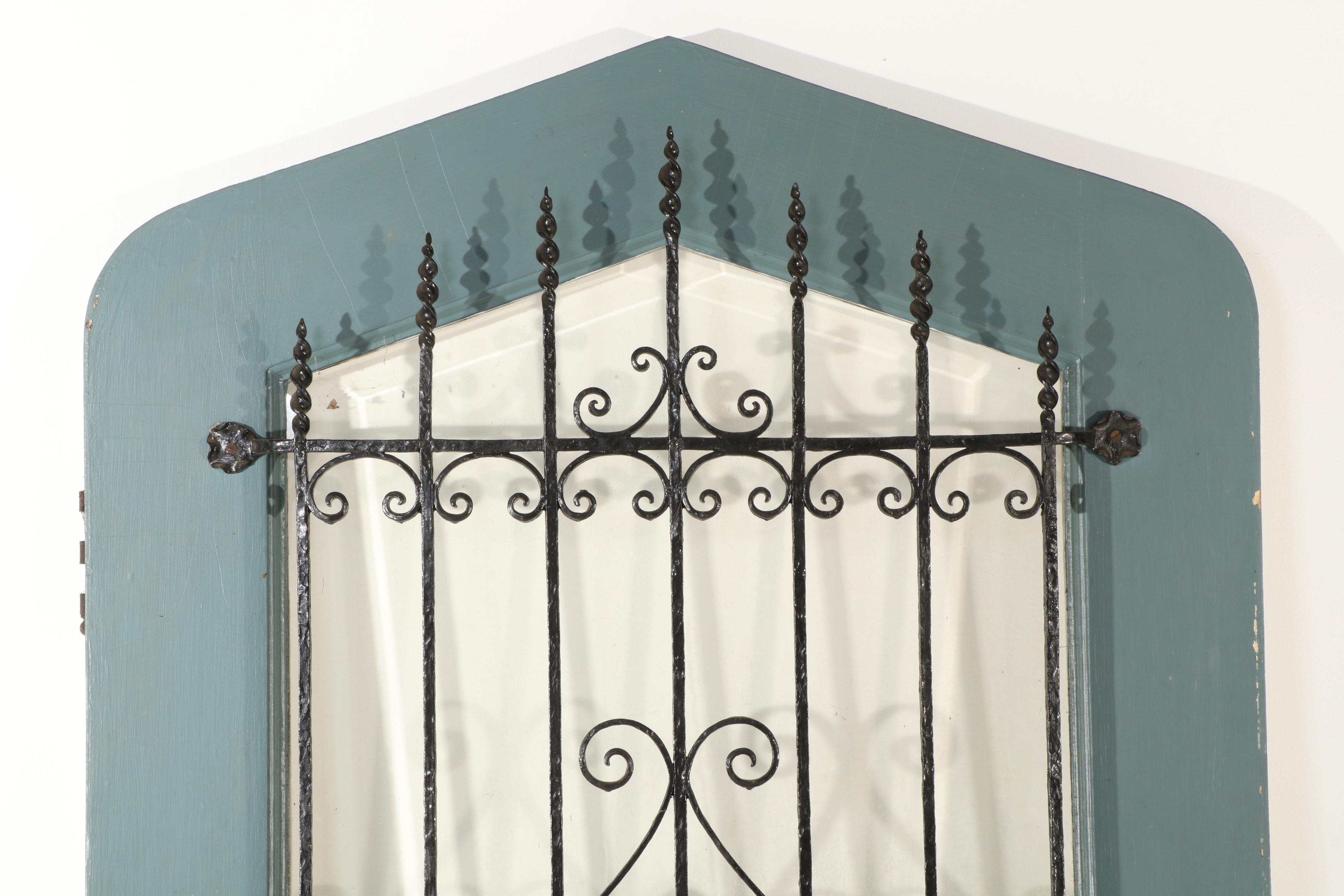 Gothic-Arched Exterior Door with Wrought Iron Grill and Beveled Glass