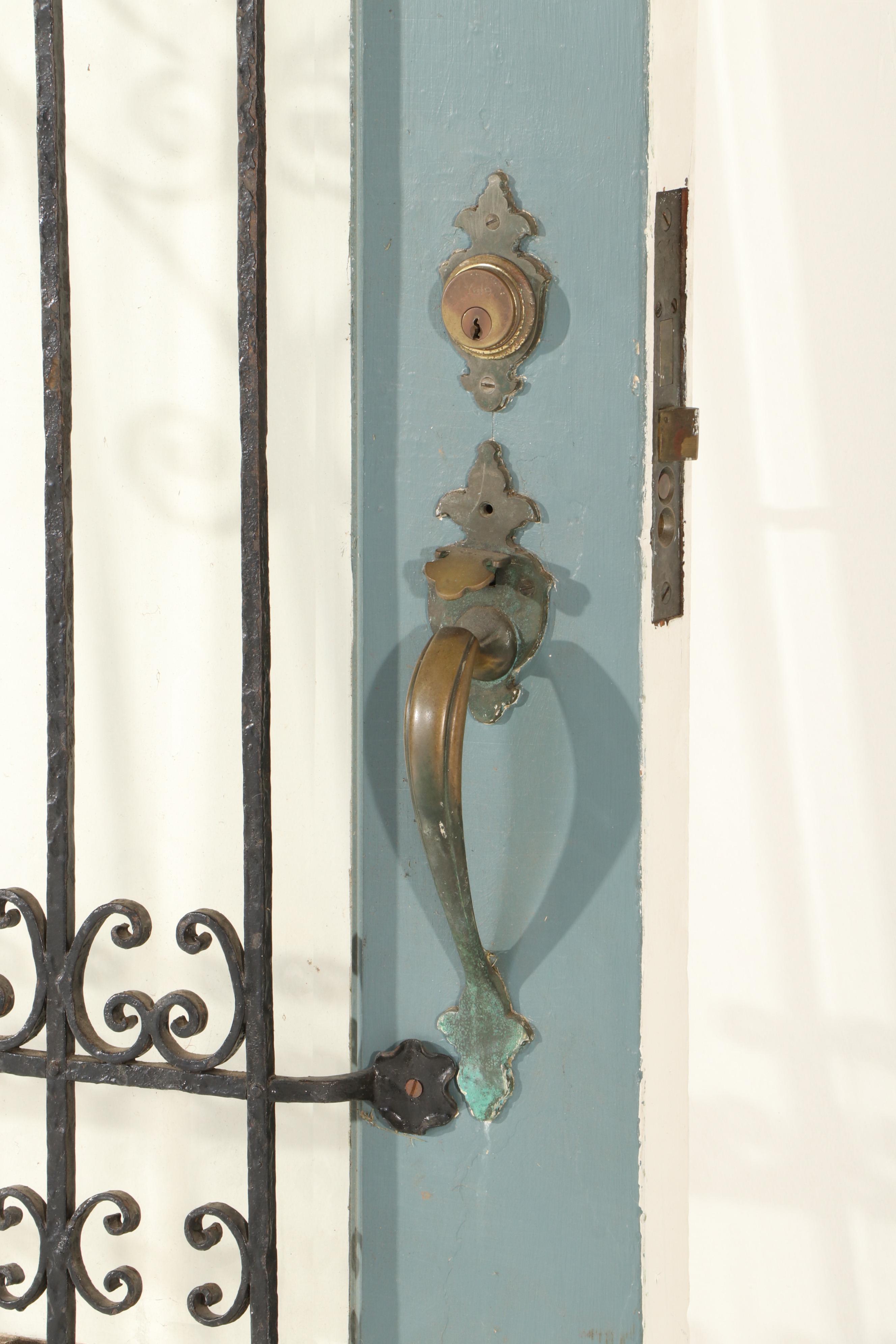 Gothic-Arched Exterior Door with Wrought Iron Grill and Beveled Glass