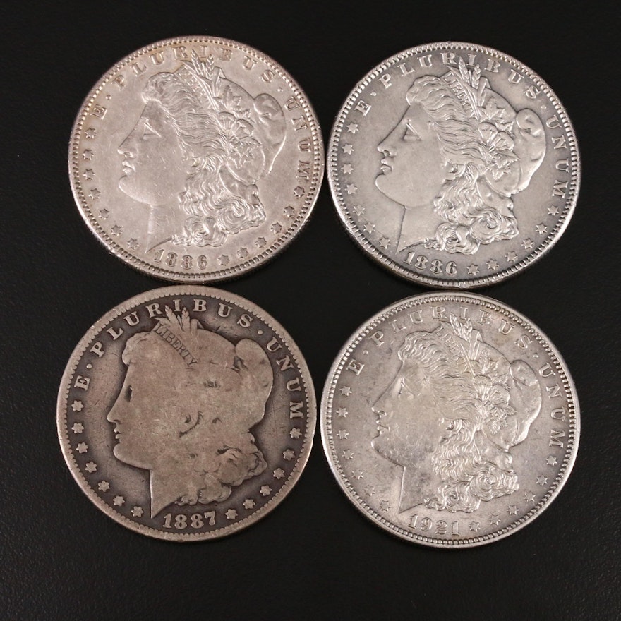 Four Silver Morgan Dollars Including an 1887-O