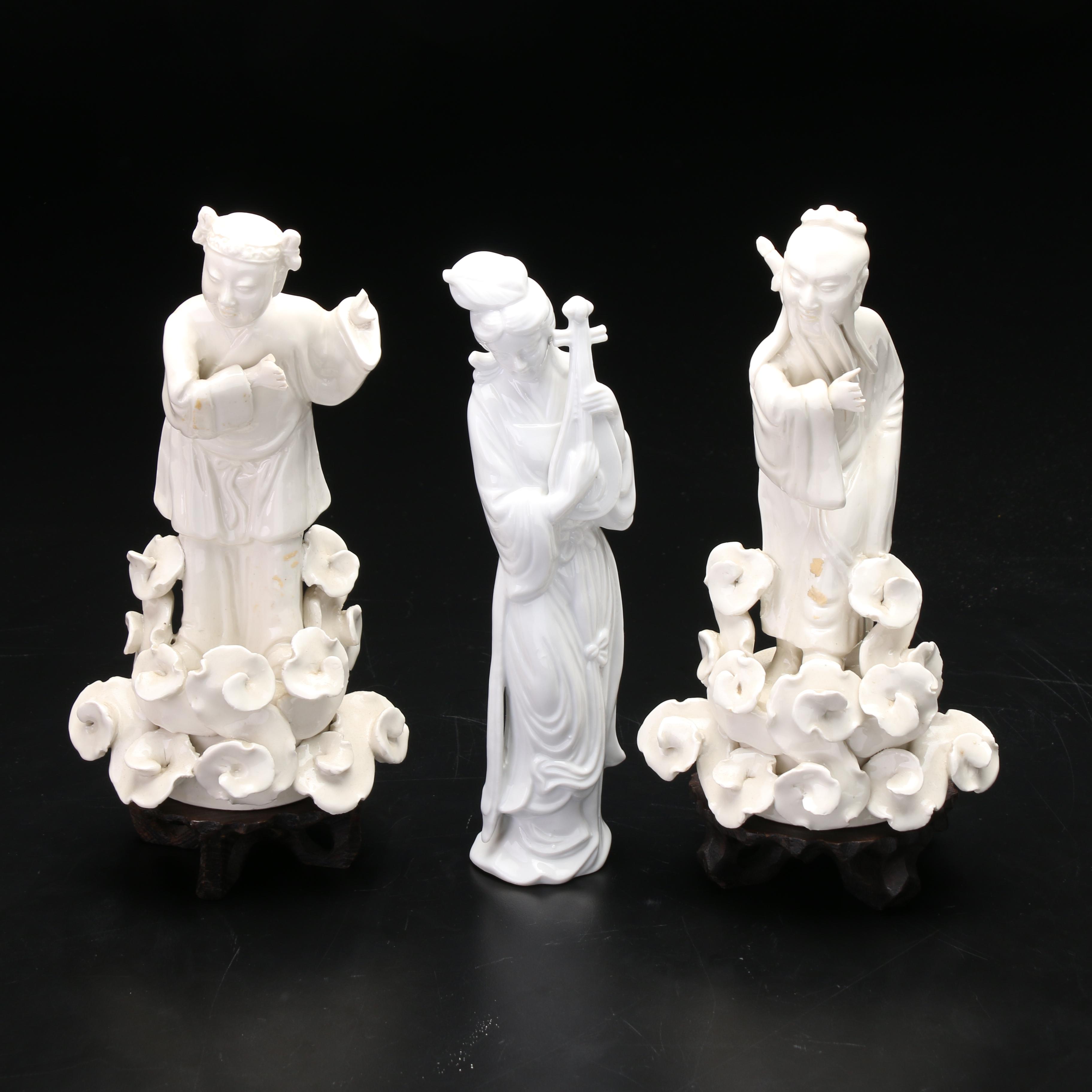Chinese Blanc de Chine Figurines with Carved Wooden Stands