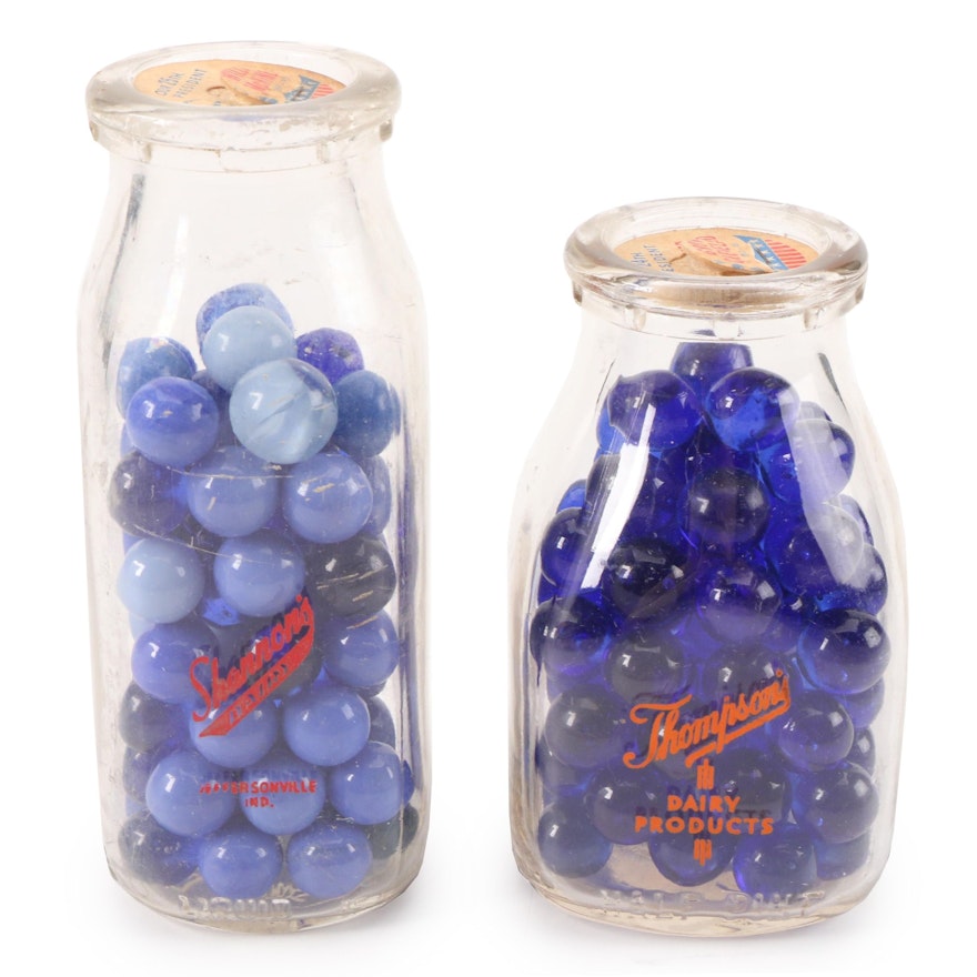 Cobalt and Other Blue Opaque and Transparent Glass Marbles in Glass Milk Bottles