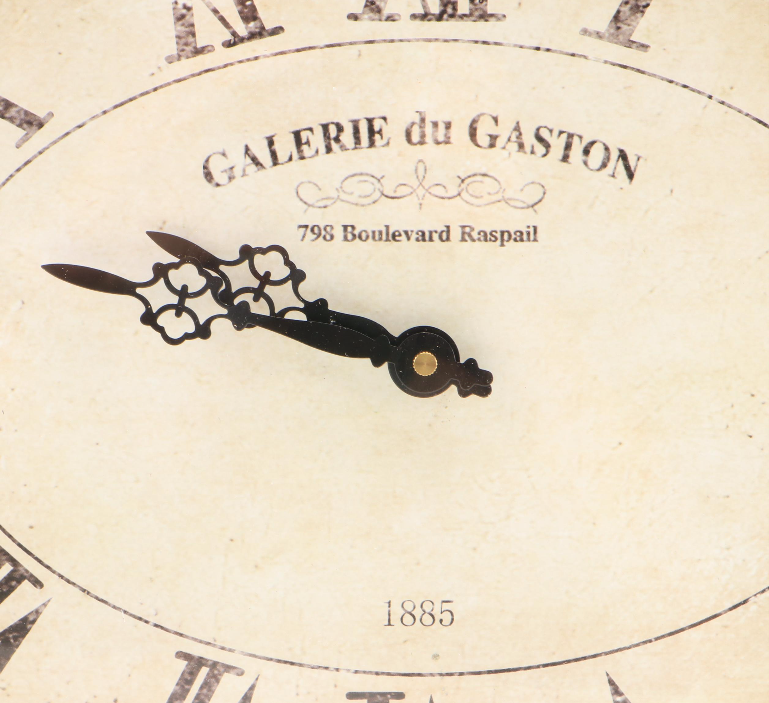 Oval Wall Clock with Cast Metal Brackets and Wooden Decor