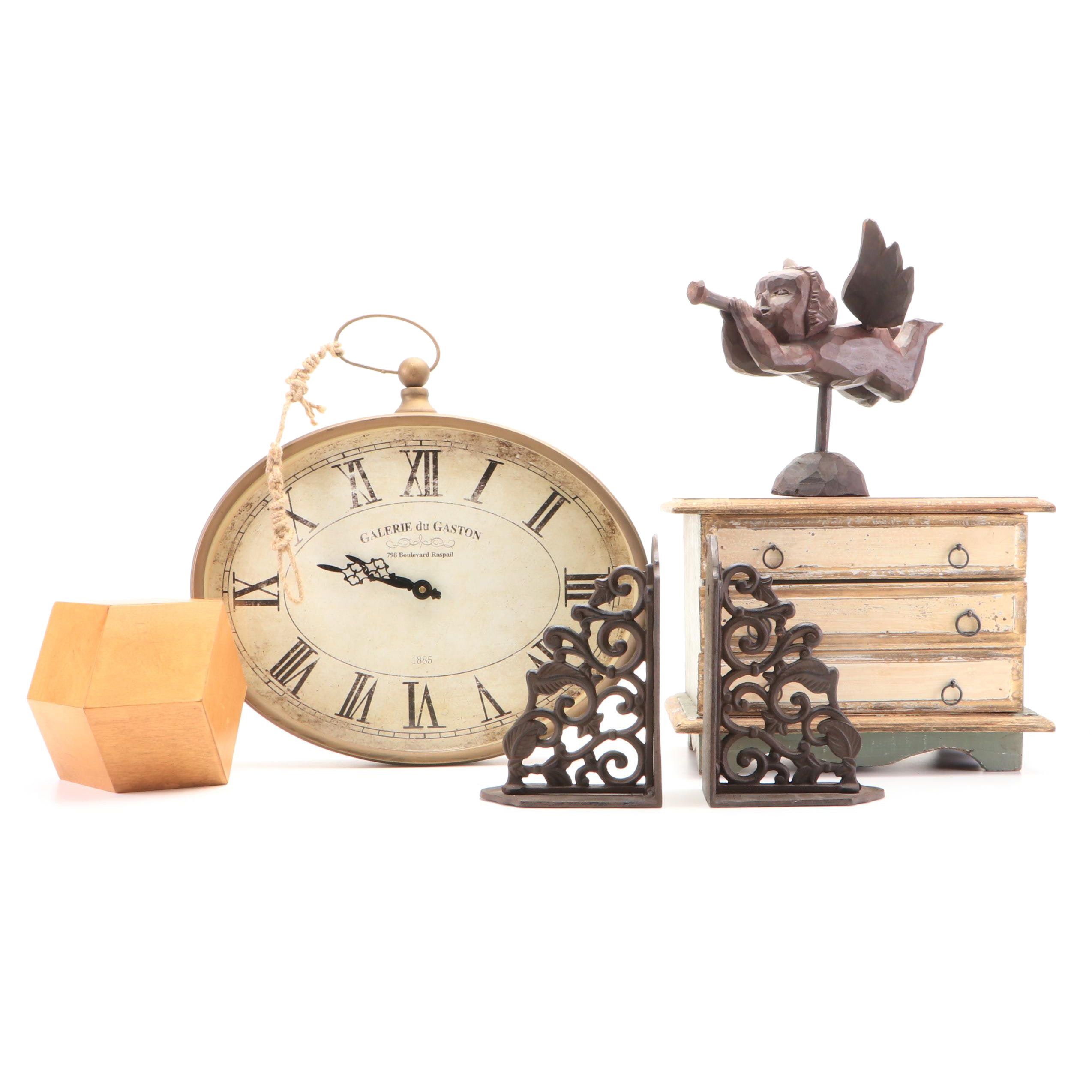 Oval Wall Clock with Cast Metal Brackets and Wooden Decor