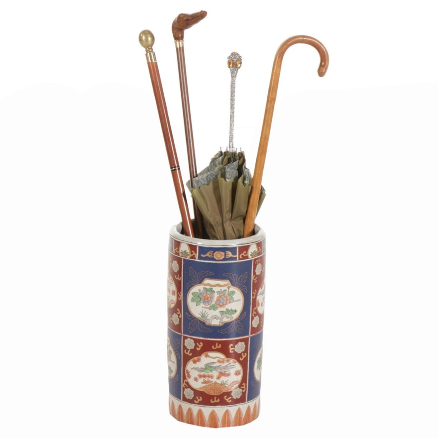 Three Wooden and Brass Canes, Earthenware Umbrella Stand, and One Umbrella