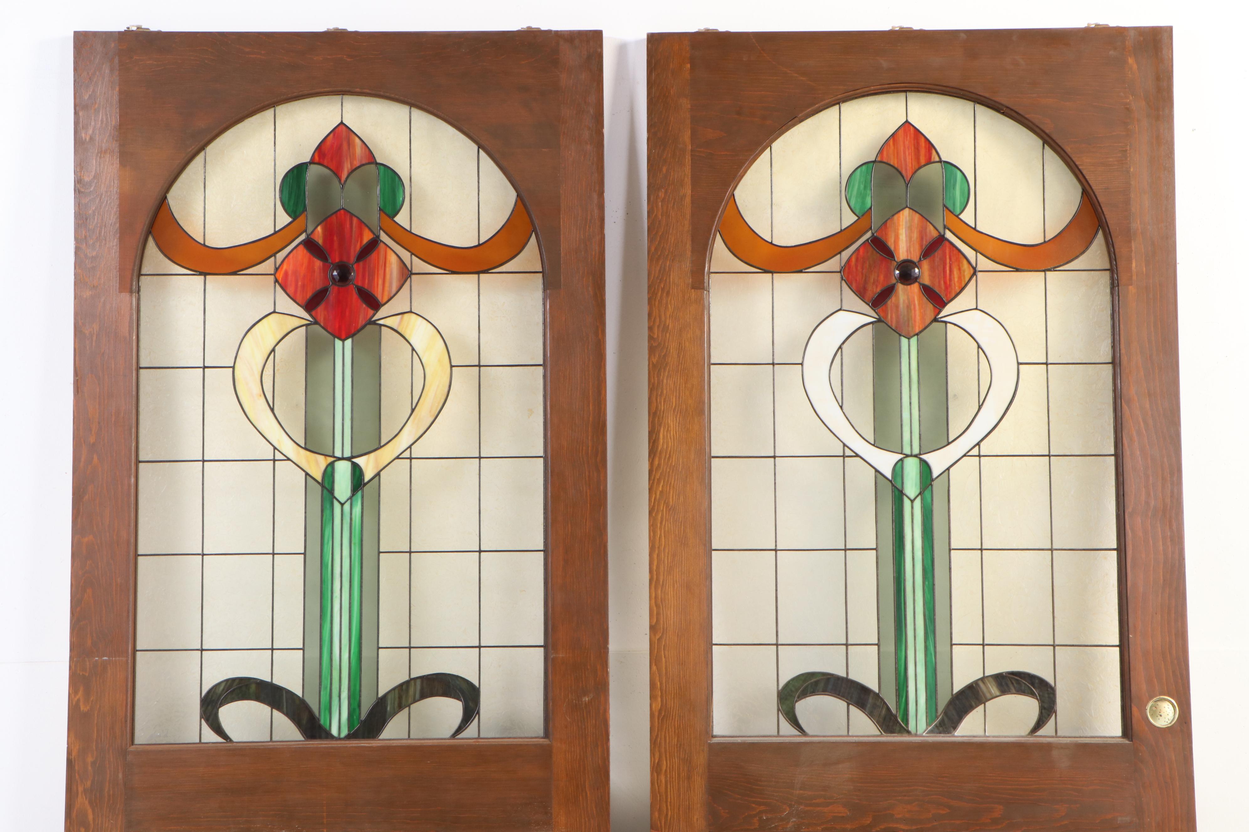 Pair of Fir Pocket Doors with Arched Leaded Stained and Slag Glass Windows