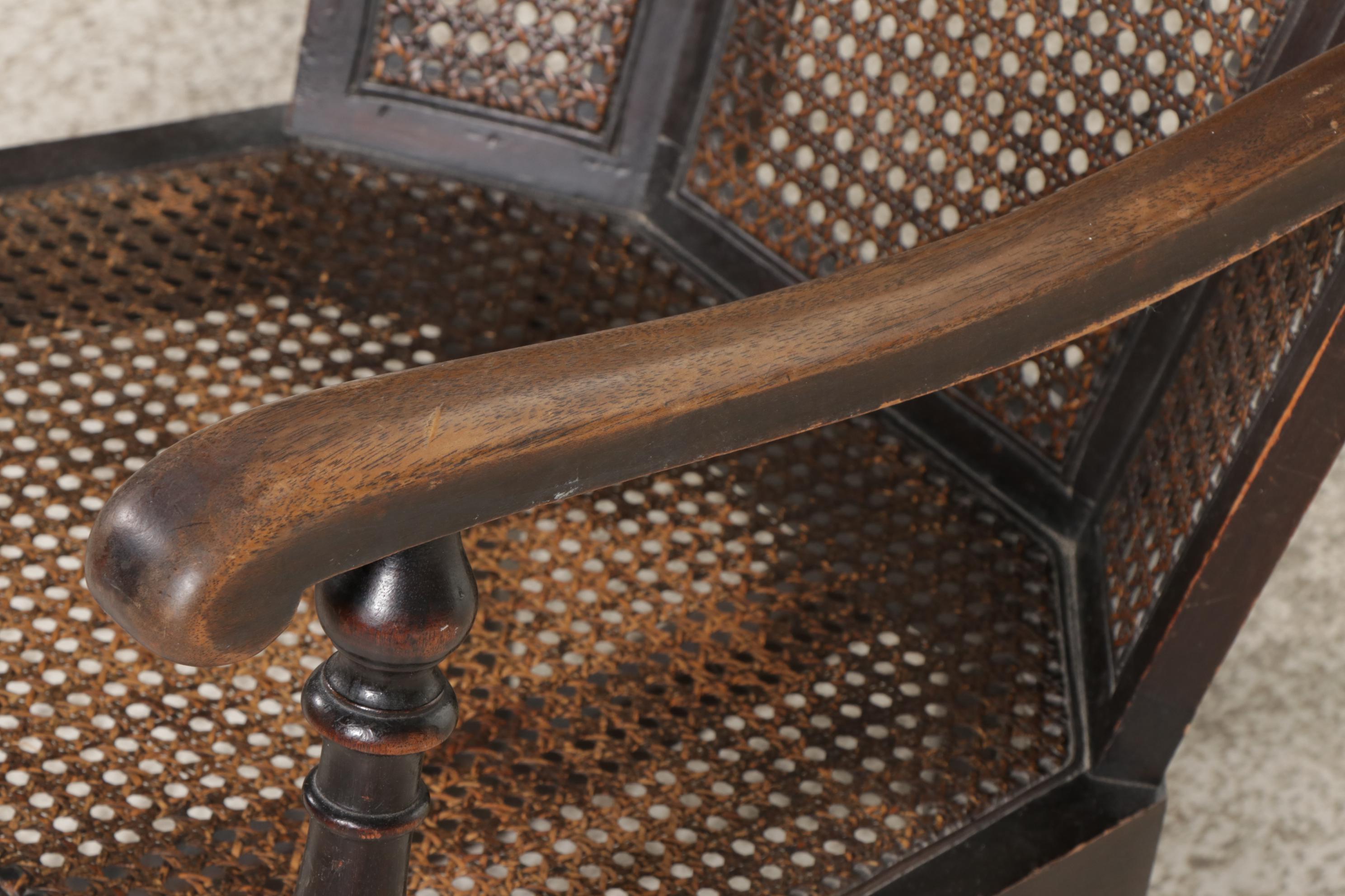 Queen Anne Style Ebonized and Caned Wingback Rocking Armchair