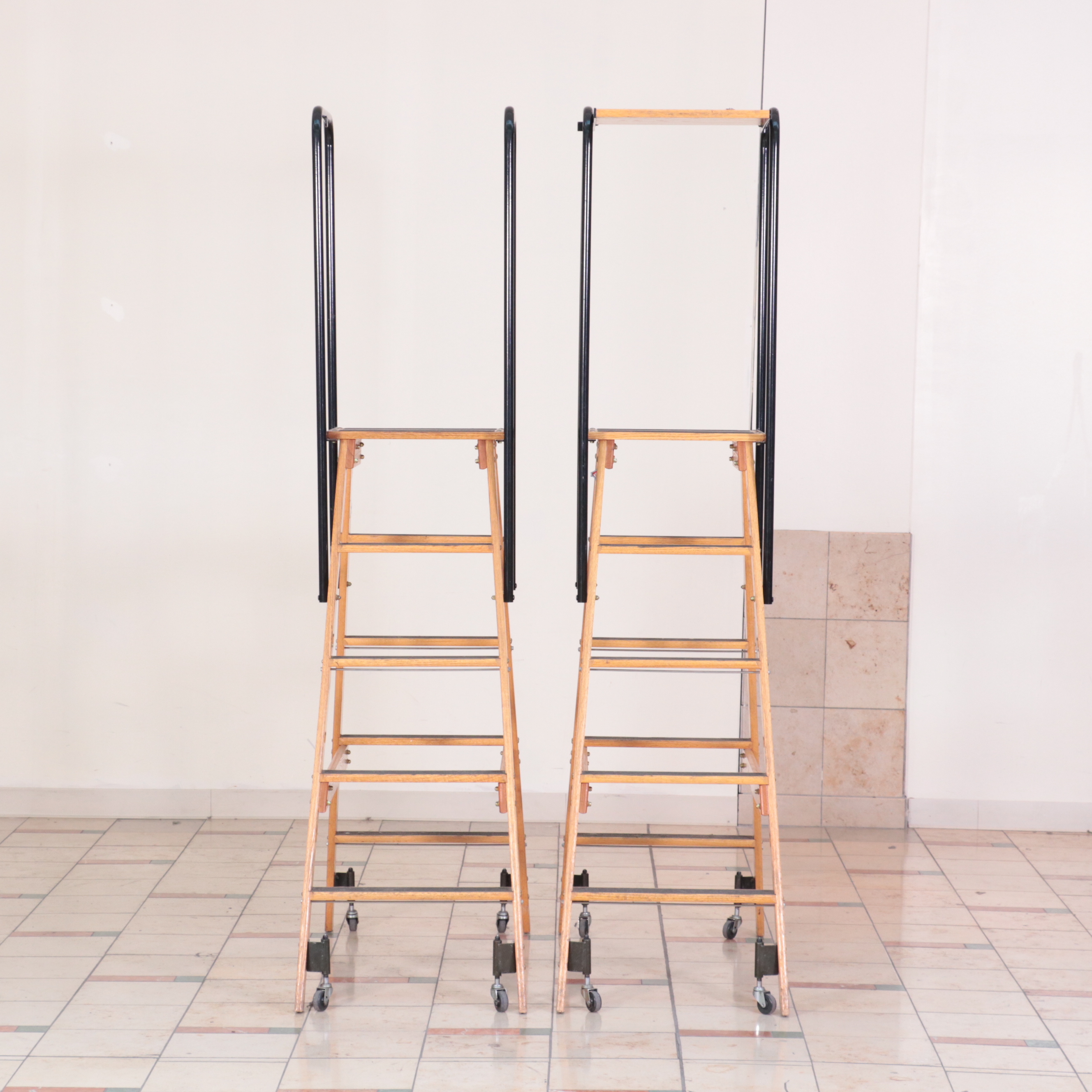 Pair of Putnam Finished Wood and Metal Rolling Ladders
