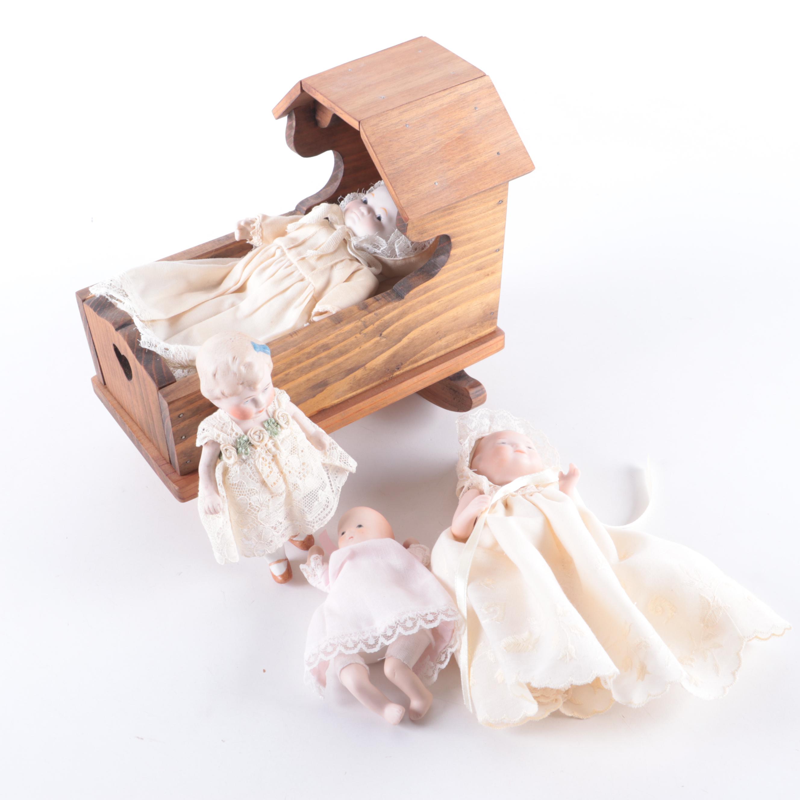 Limbach and Other Bisque Porcelain Dolls with Cradle