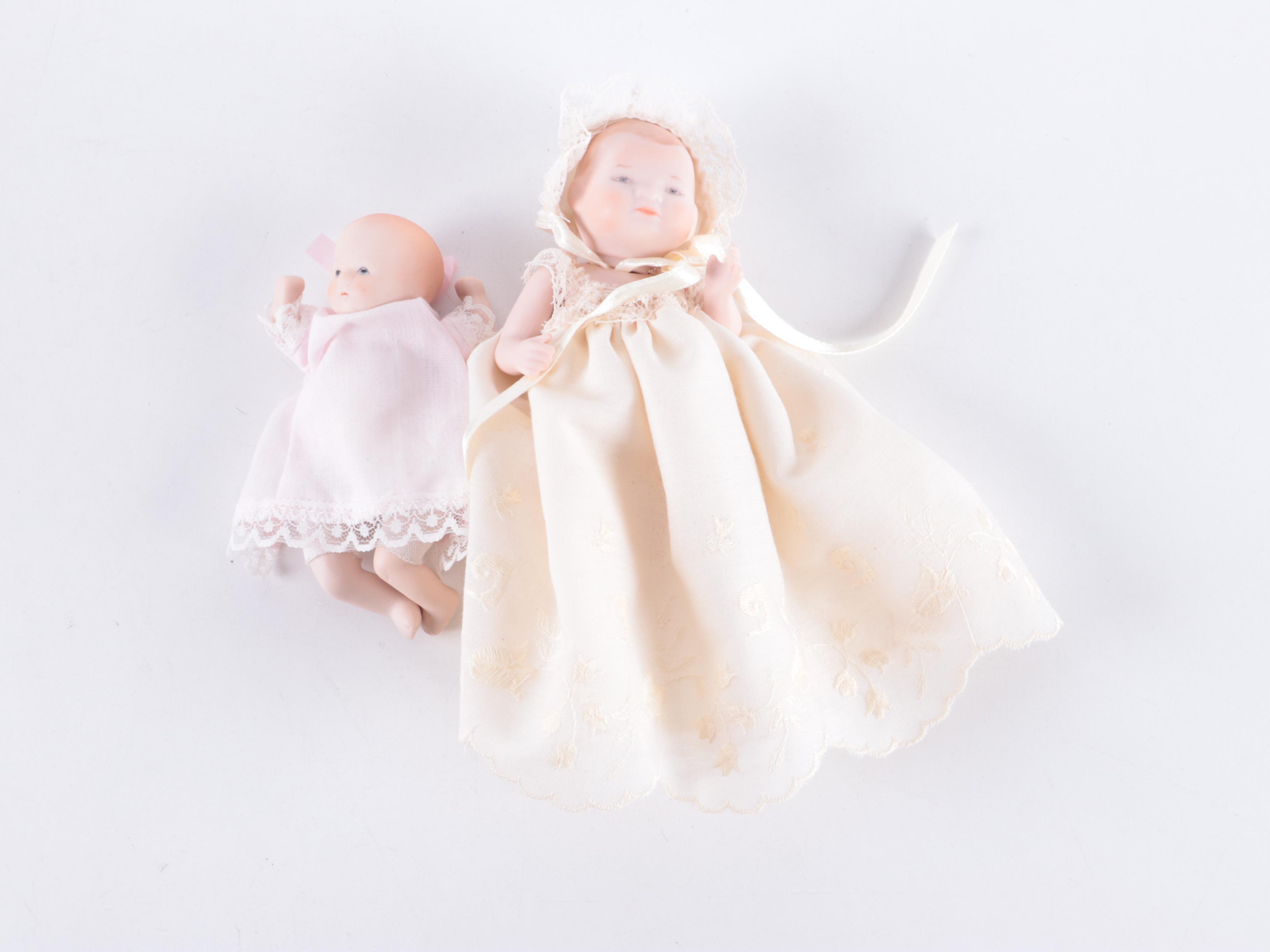 Limbach and Other Bisque Porcelain Dolls with Cradle