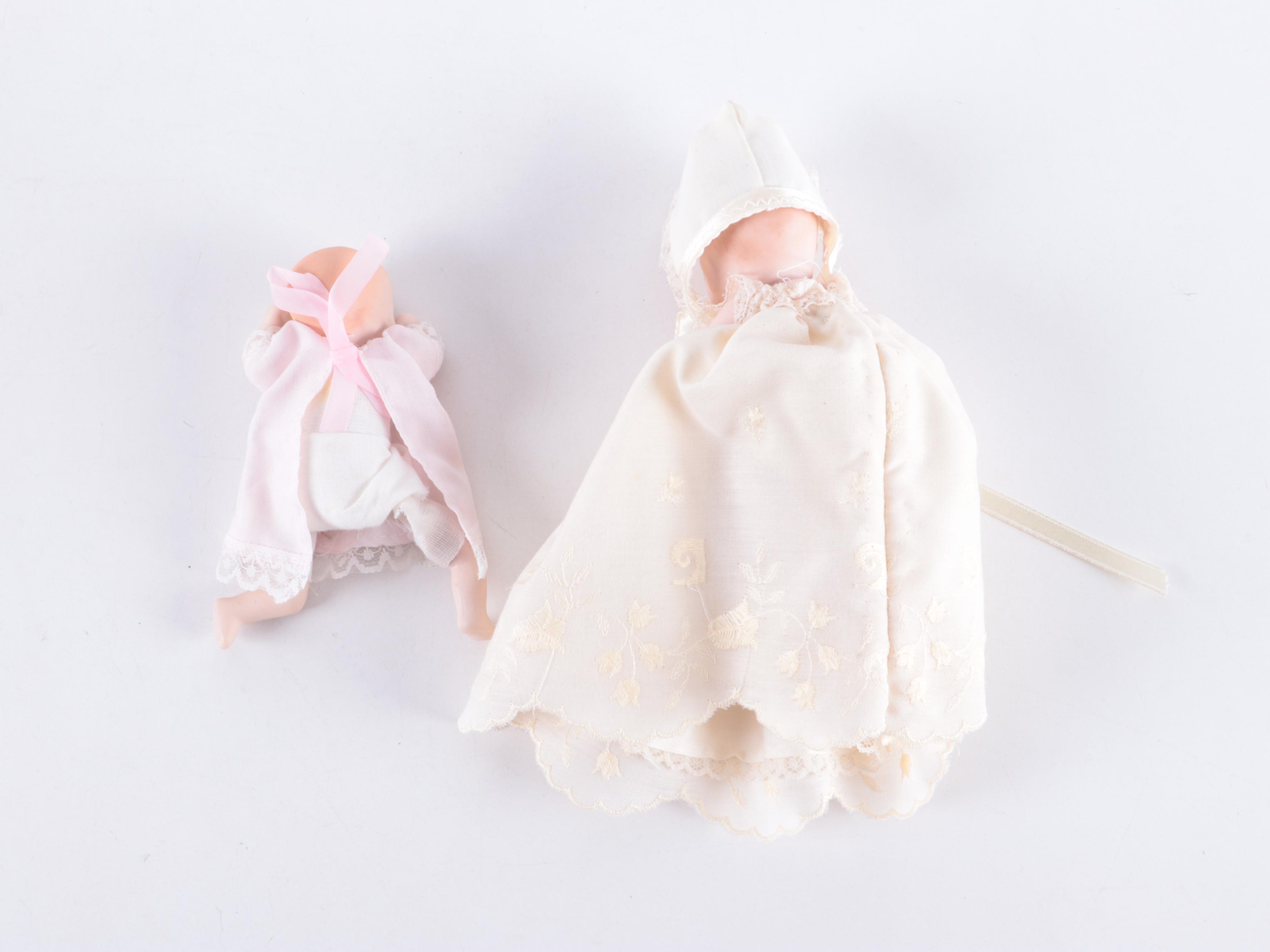 Limbach and Other Bisque Porcelain Dolls with Cradle