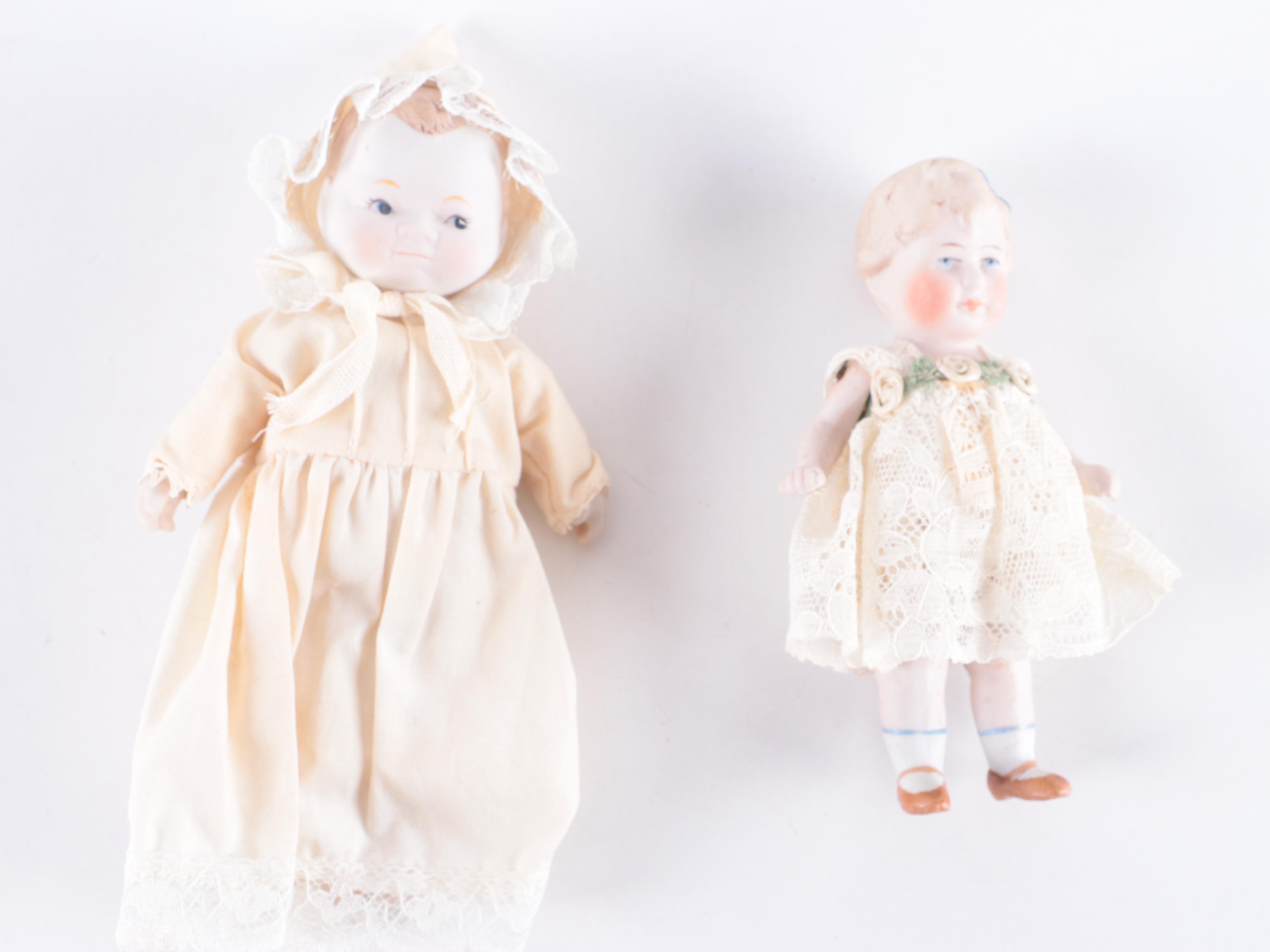 Limbach and Other Bisque Porcelain Dolls with Cradle