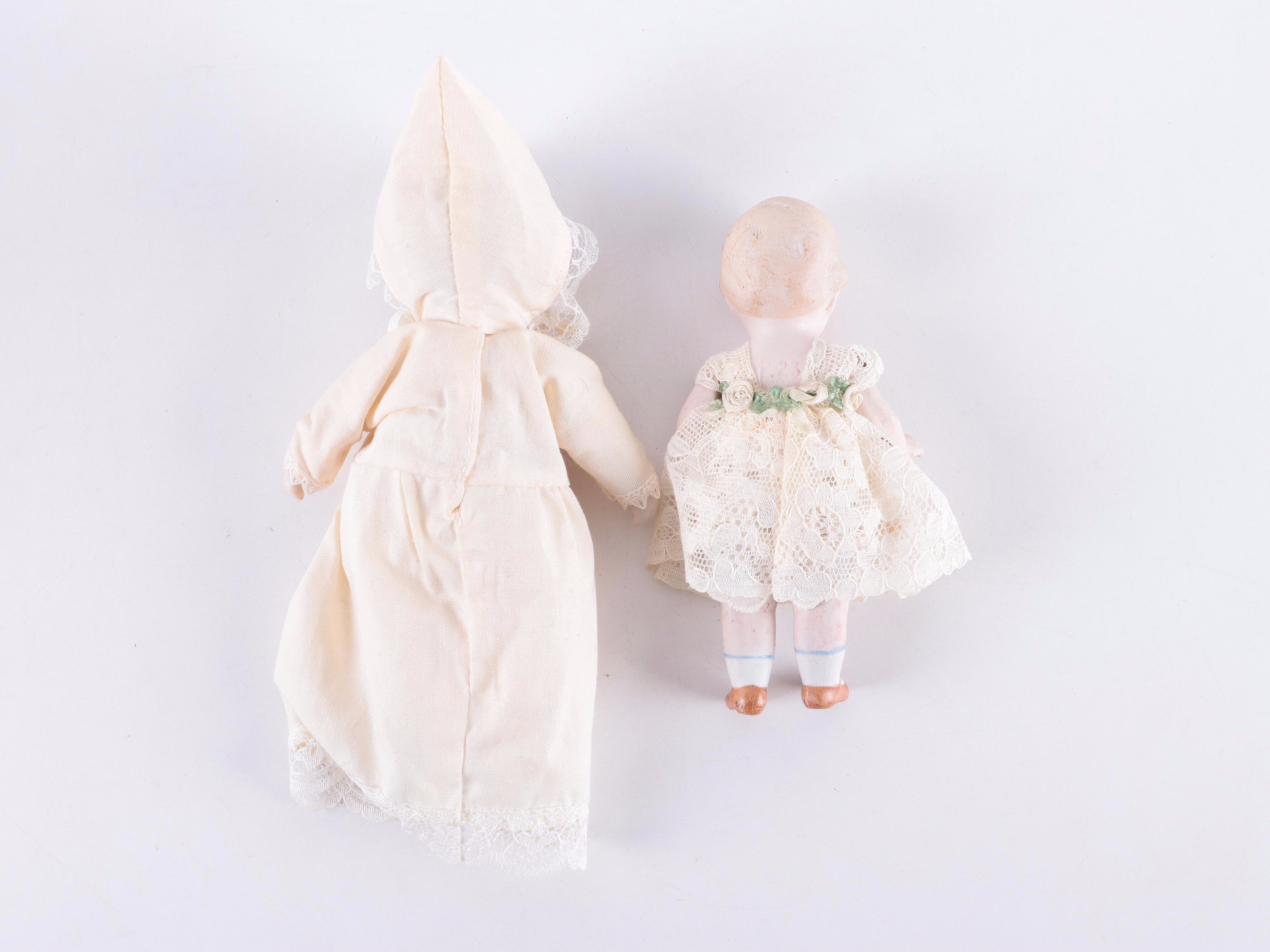 Limbach and Other Bisque Porcelain Dolls with Cradle