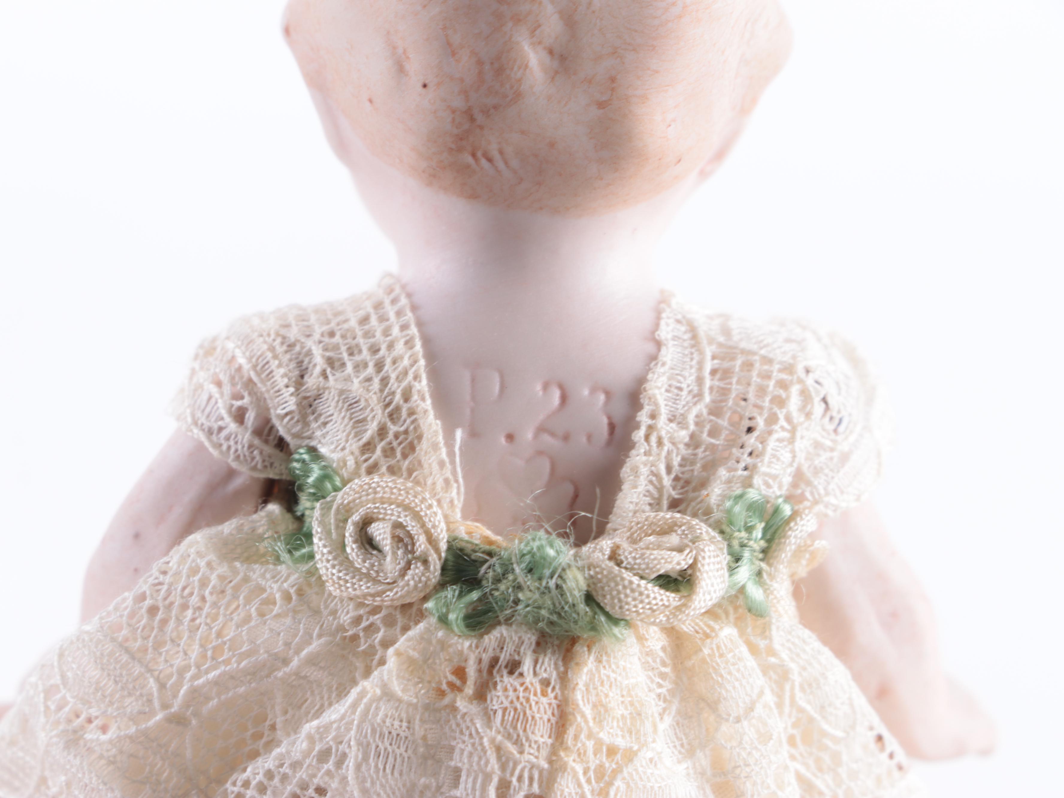 Limbach and Other Bisque Porcelain Dolls with Cradle