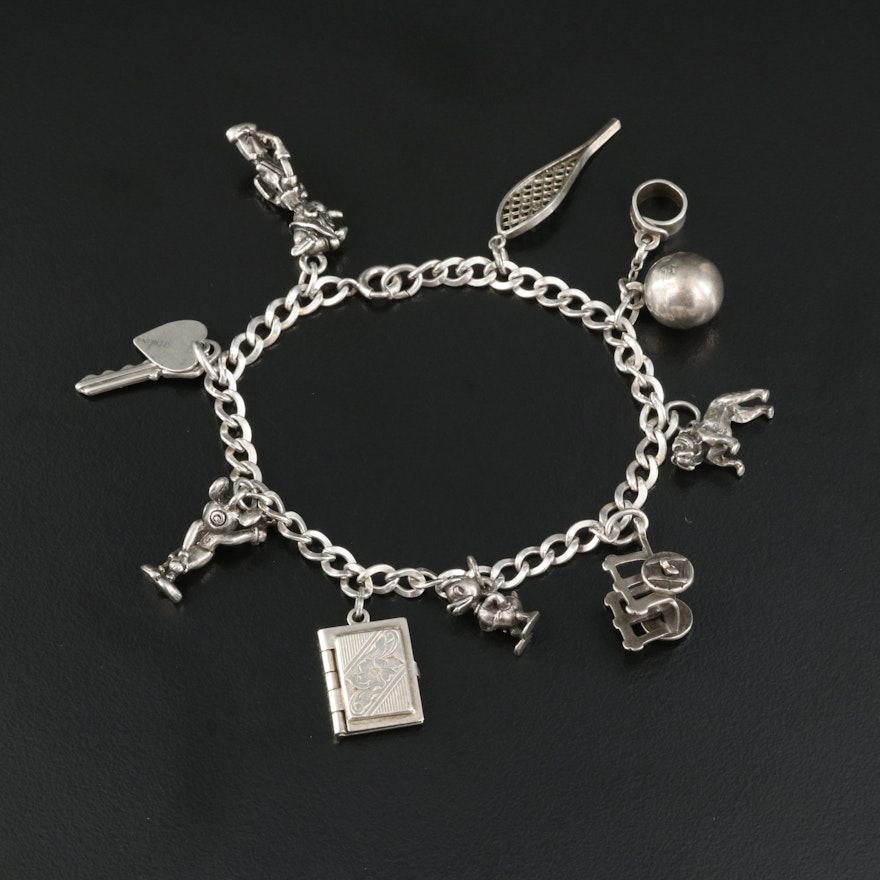 Sterling Charm Bracelet Featured with Articulated Cart and Locket Charms