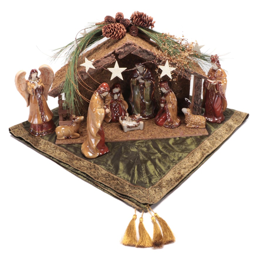 Glazed Ceramic Nativity Figurines with Wooden Stable and Tasseled Tree Skirt